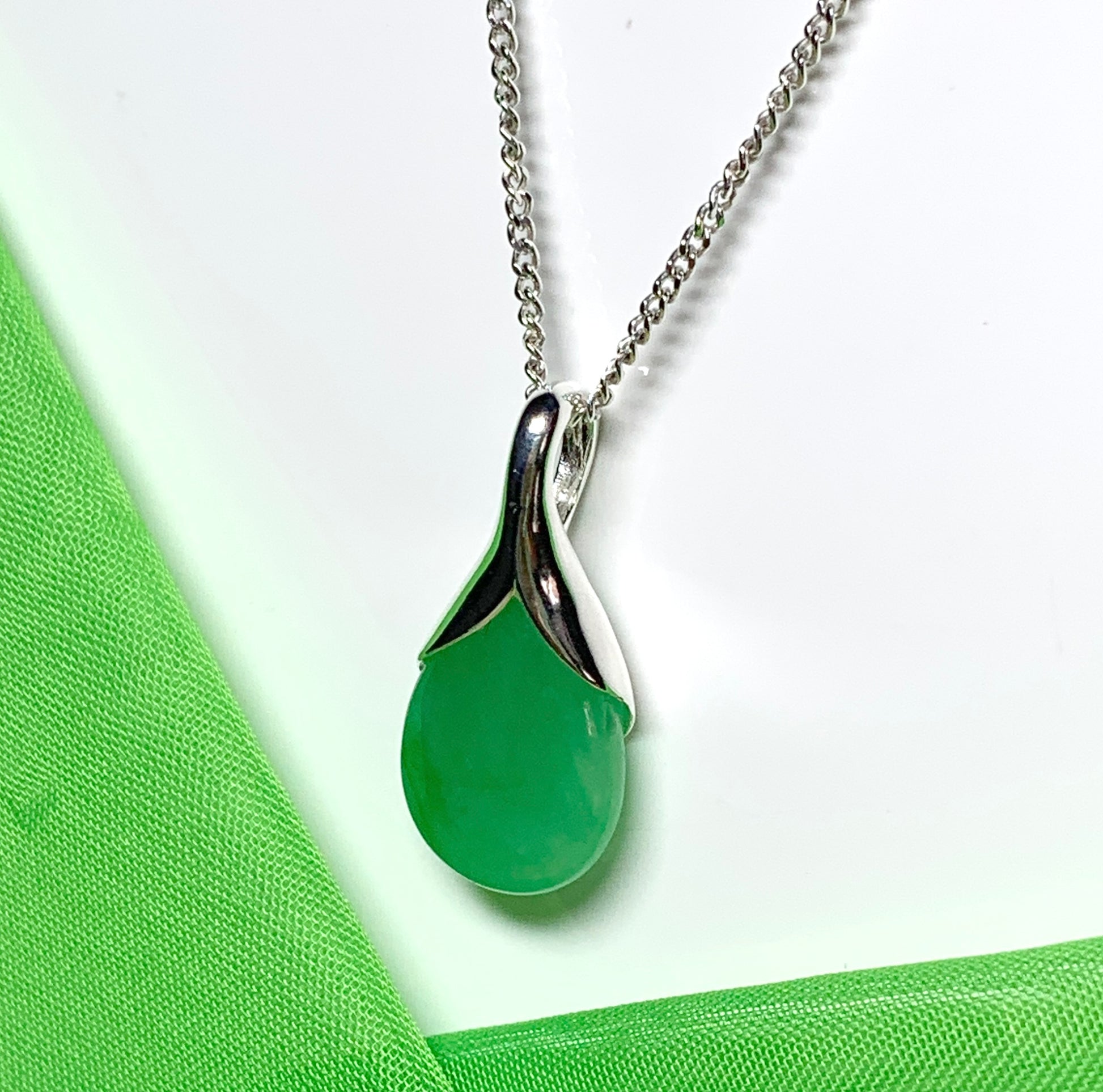 A real green jade necklace in a teardrop shaped or pear shape