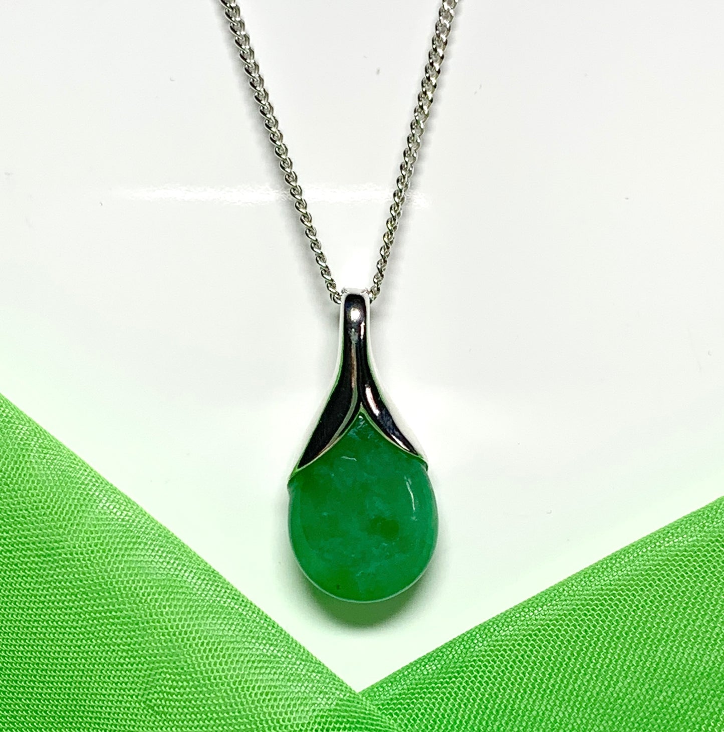 A real green jade necklace in a tear drop or pear shape