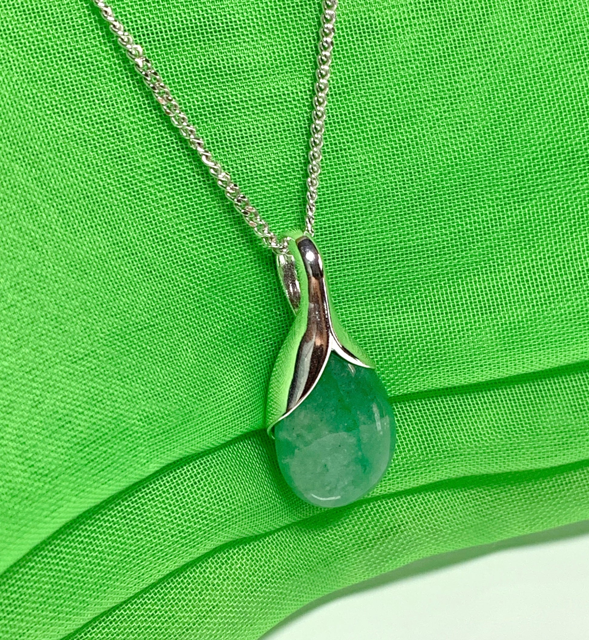 A real green jade necklace in a teardrop or pear shaped