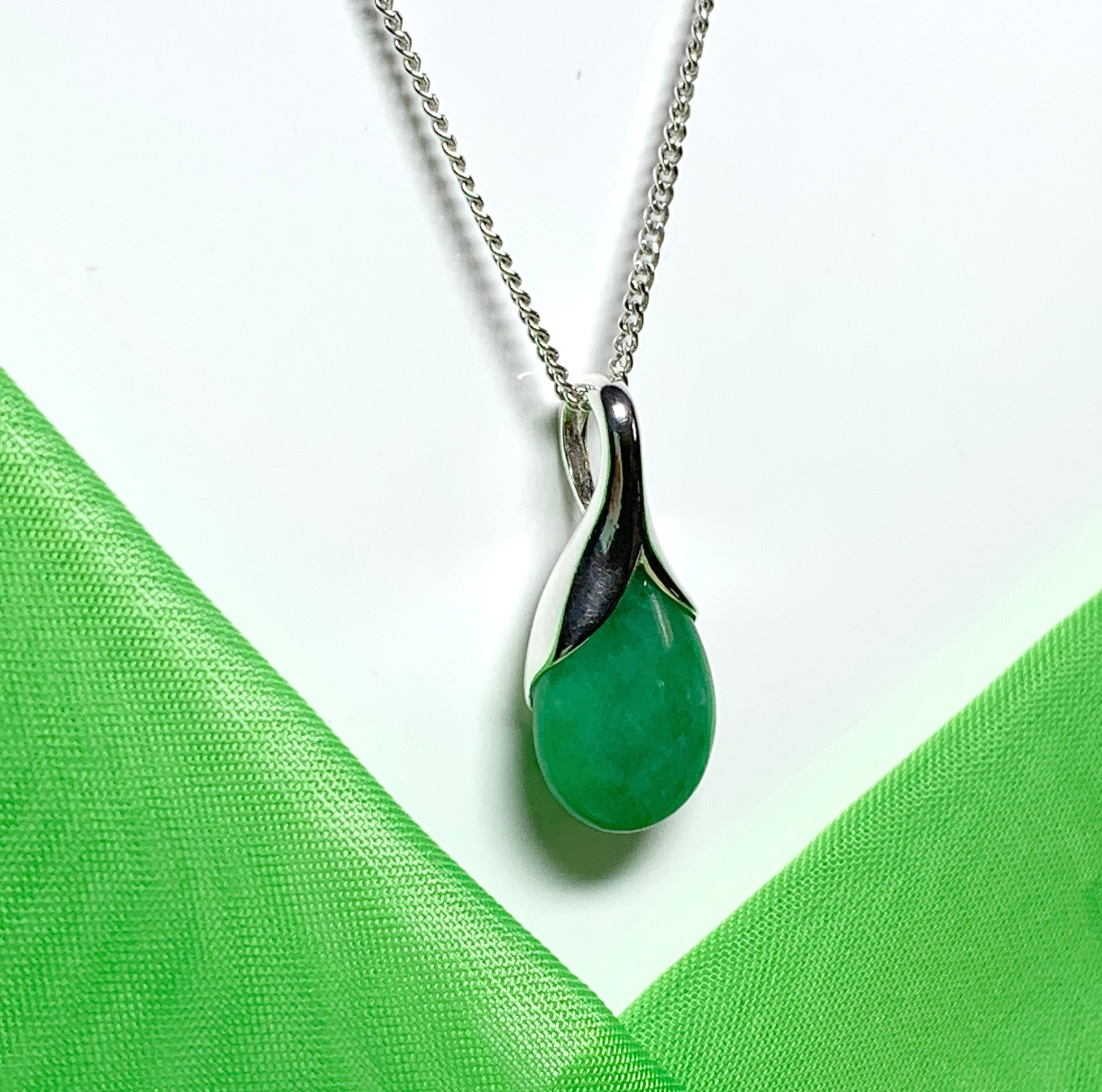 A real green jade necklace in a tear drop or pear shape pendant