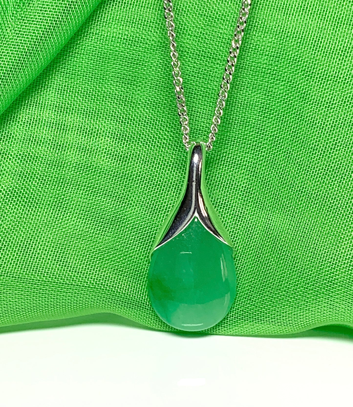 A real green jade necklace in a teardrop shaped or pear shape