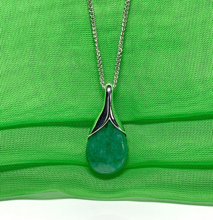 A real green jade pendant necklace in a teardrop shaped or pear shaped