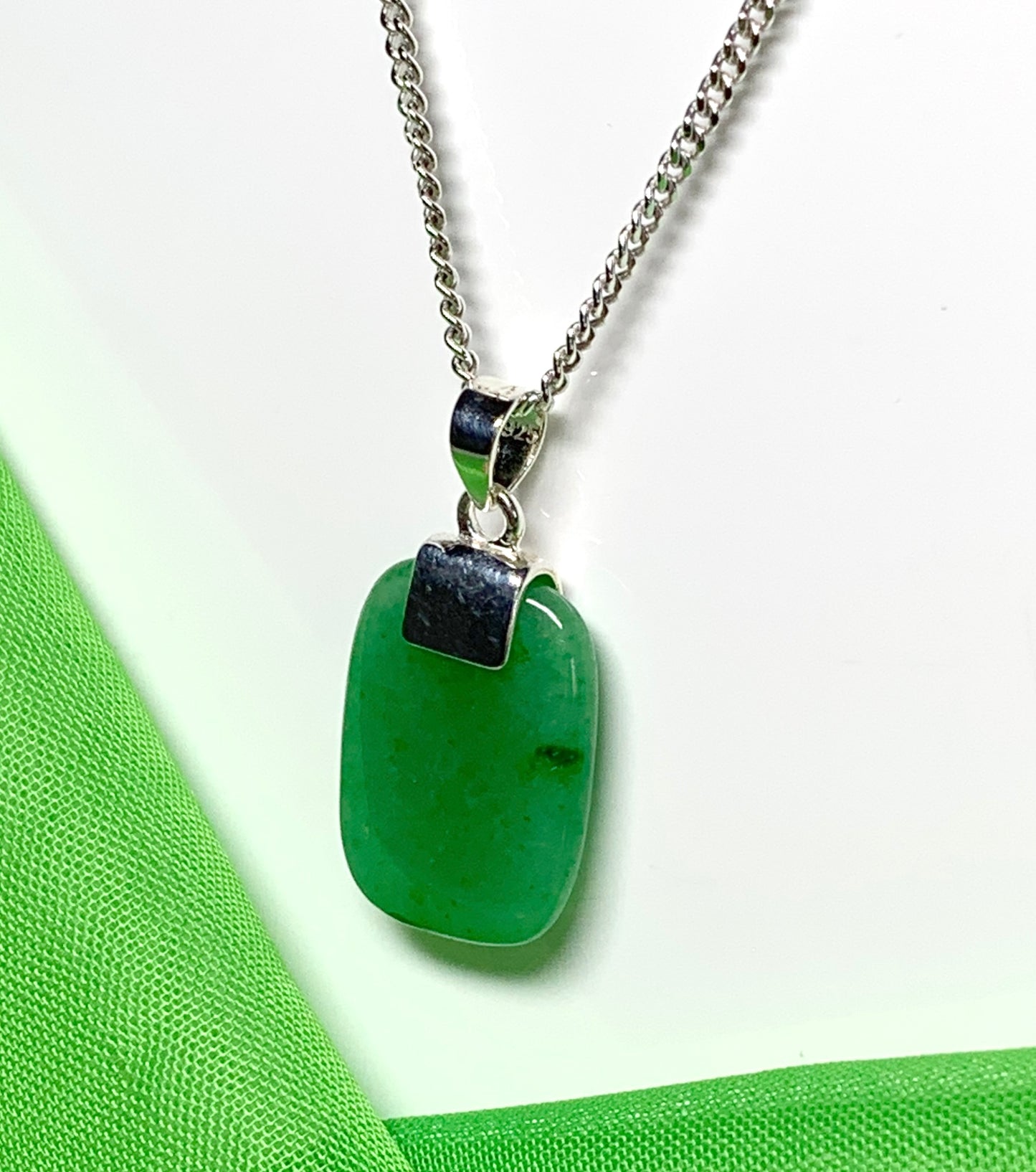 A real green jade sterling silver cushion shaped pendant