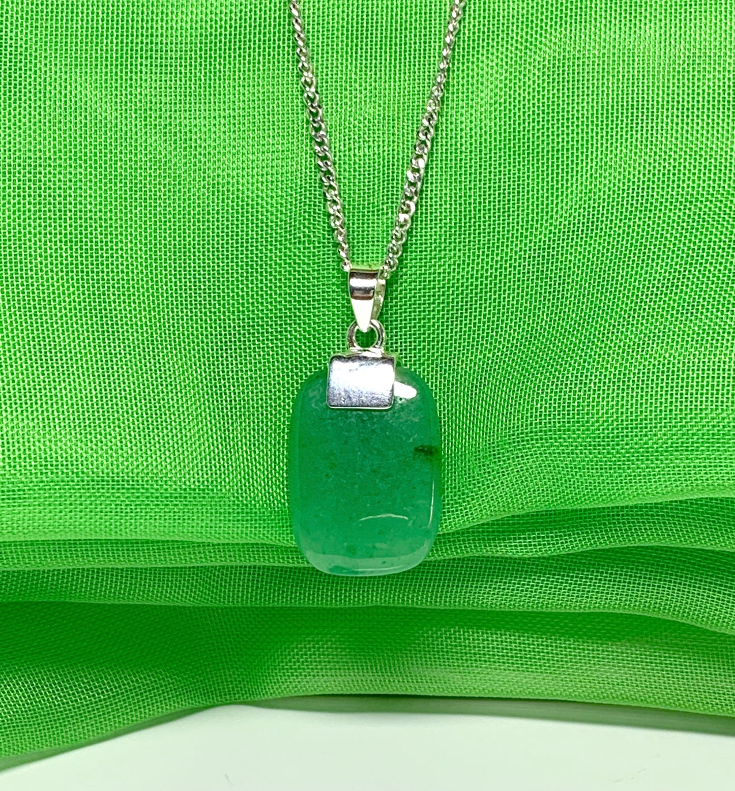 A real green jade sterling silver cushion shaped pendant