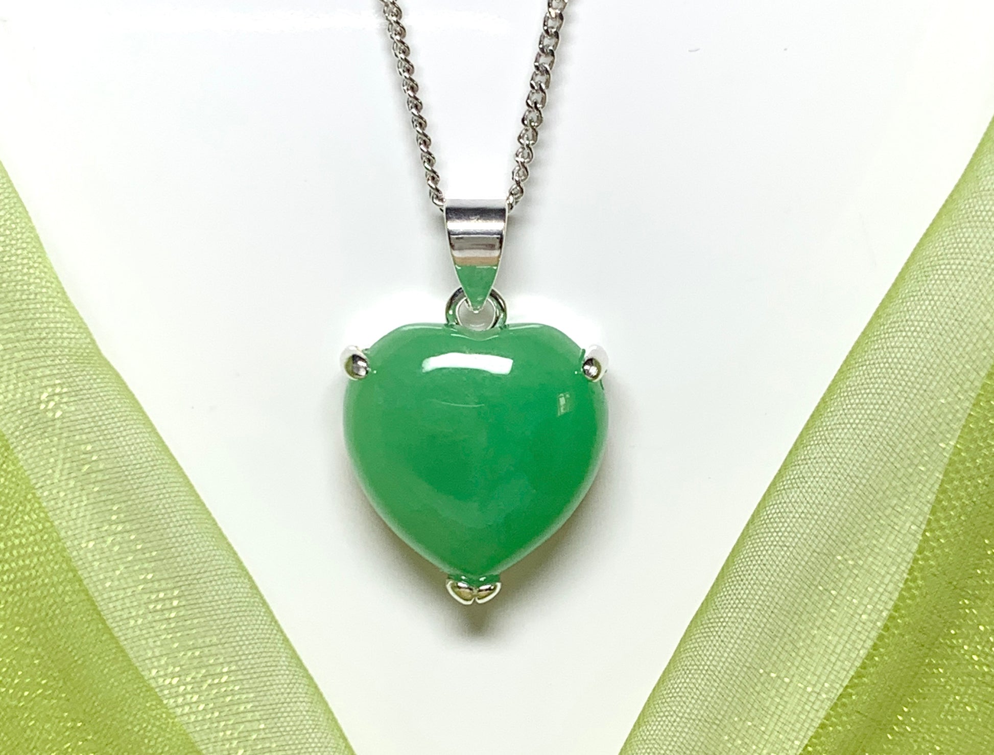 A really stunning real green jade necklace heart shaped sterling silver pendant