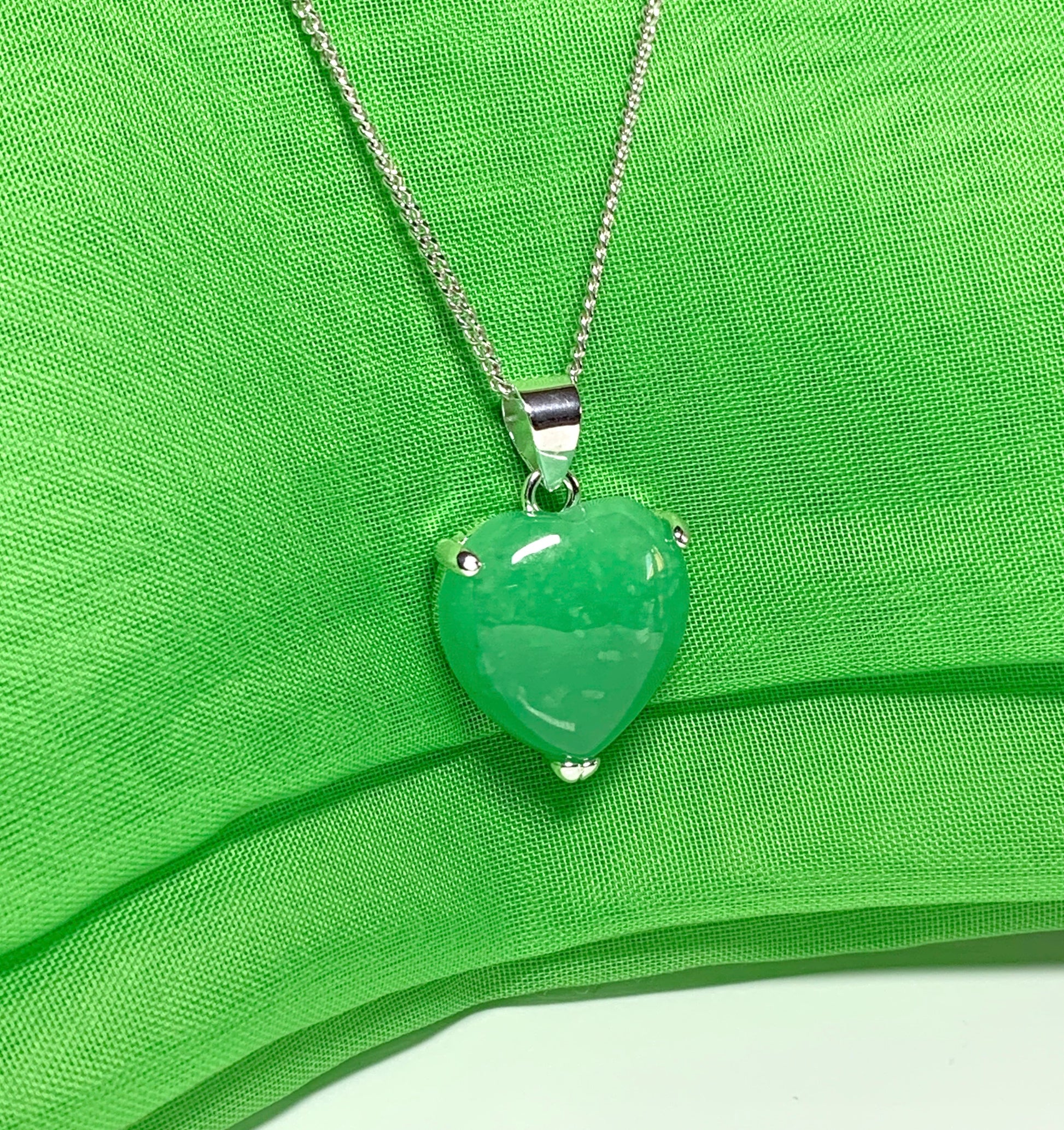 A stunning real green jade necklace heart shaped sterling silver pendant