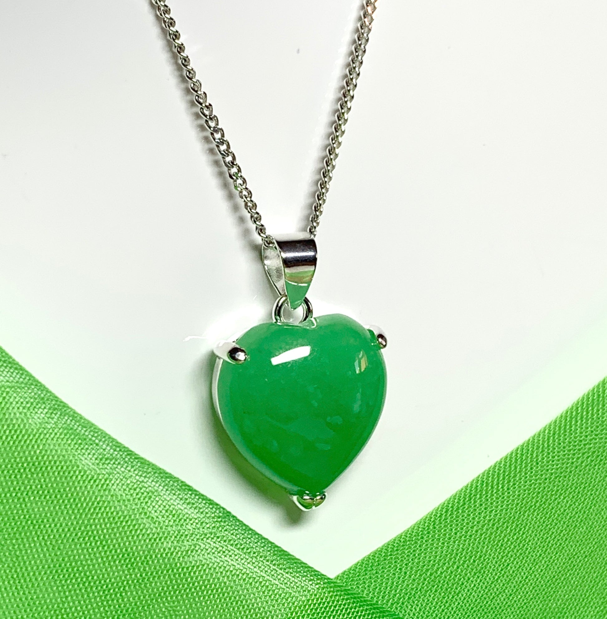 A stunning real green jade necklace heart shaped sterling silver pendant