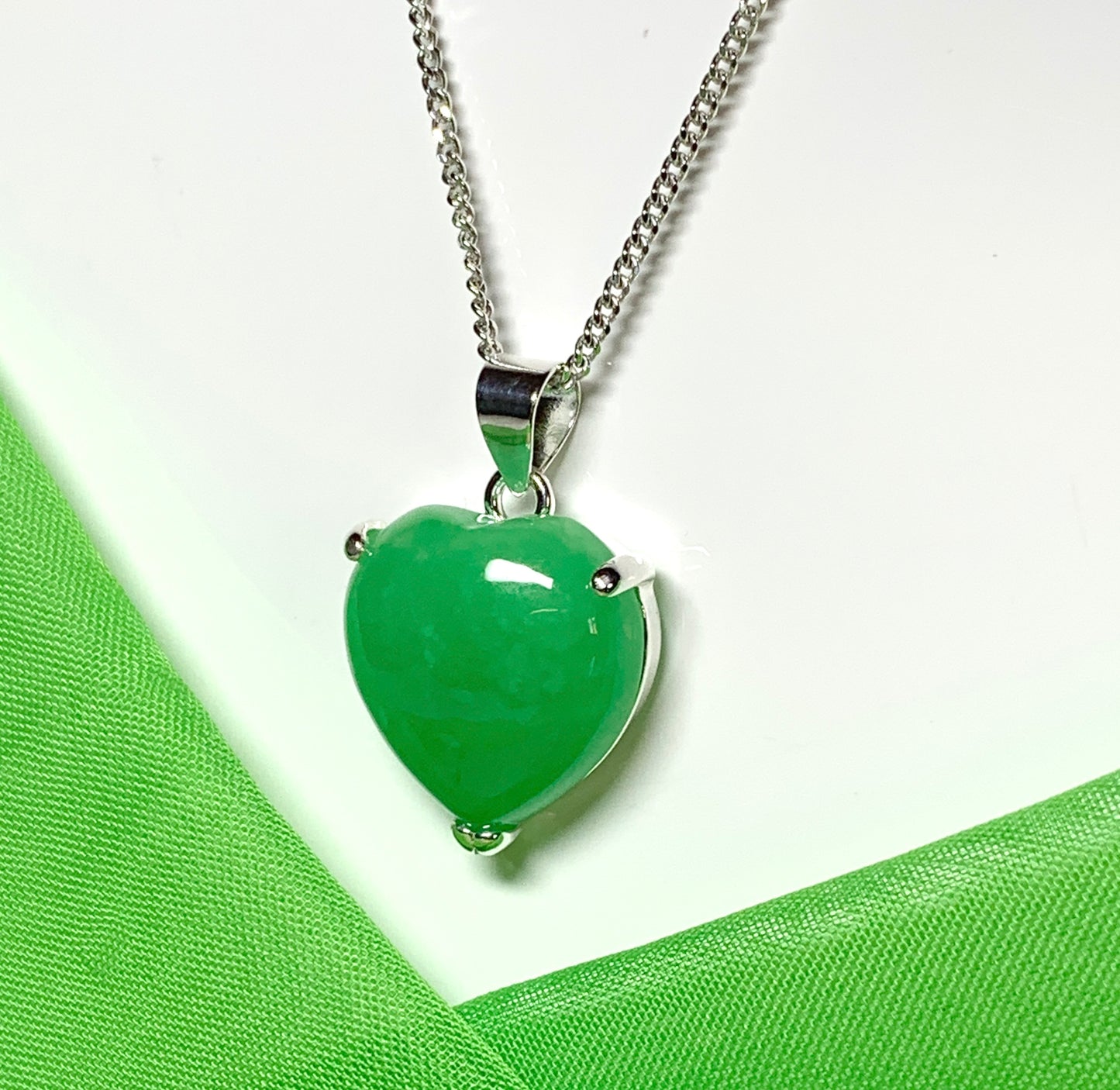 A stunning real green jade necklace heart shaped sterling silver pendant