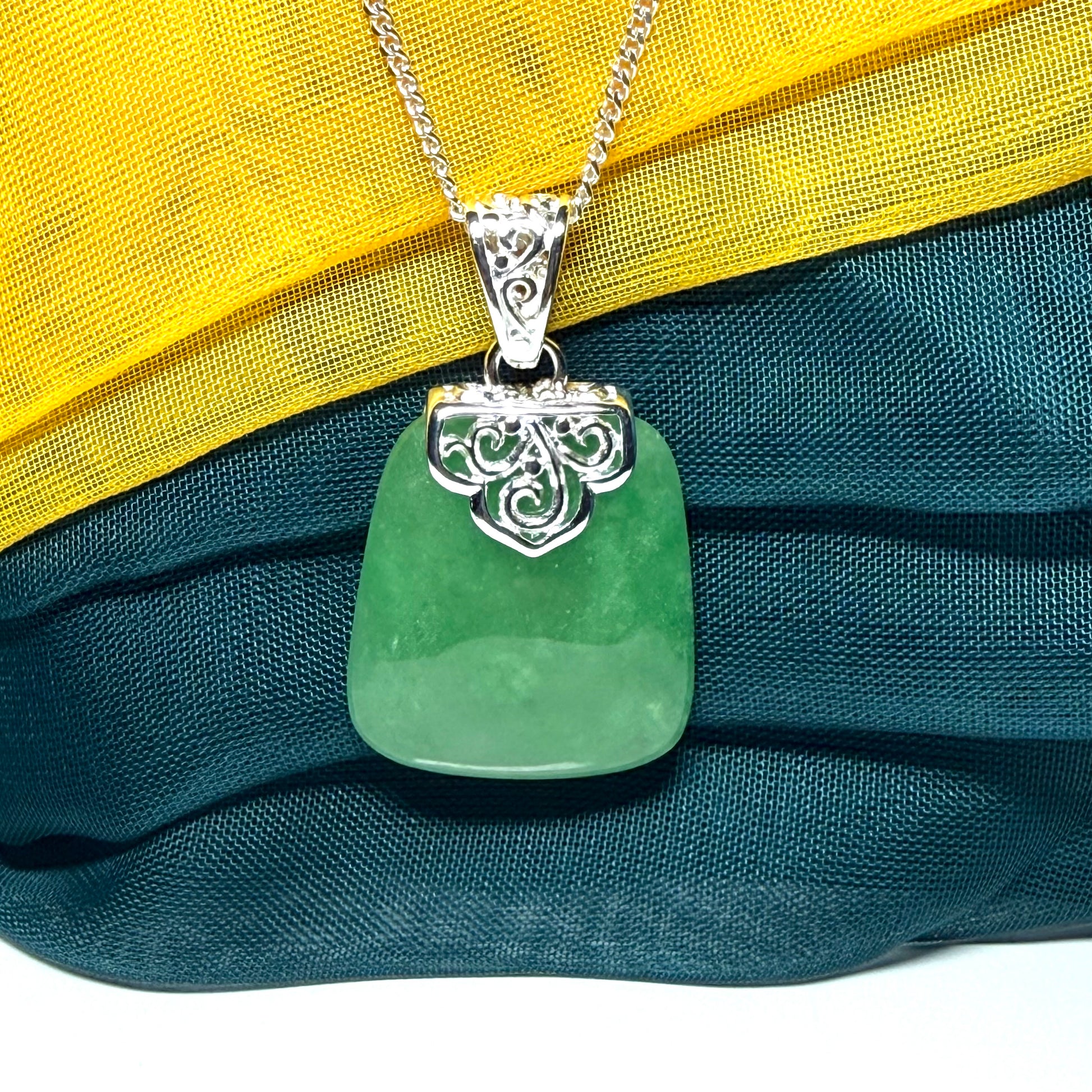 A beautiful and truly timeless real green jade necklace large pendant that is cushion shaped