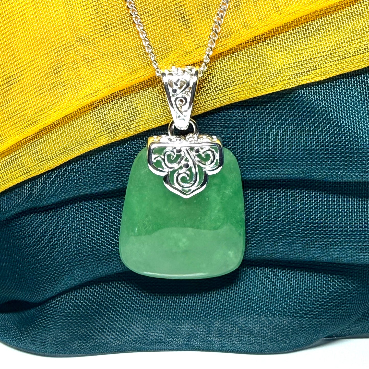 A beautiful and truly timeless real green jade necklace large pendant that is cushion shaped