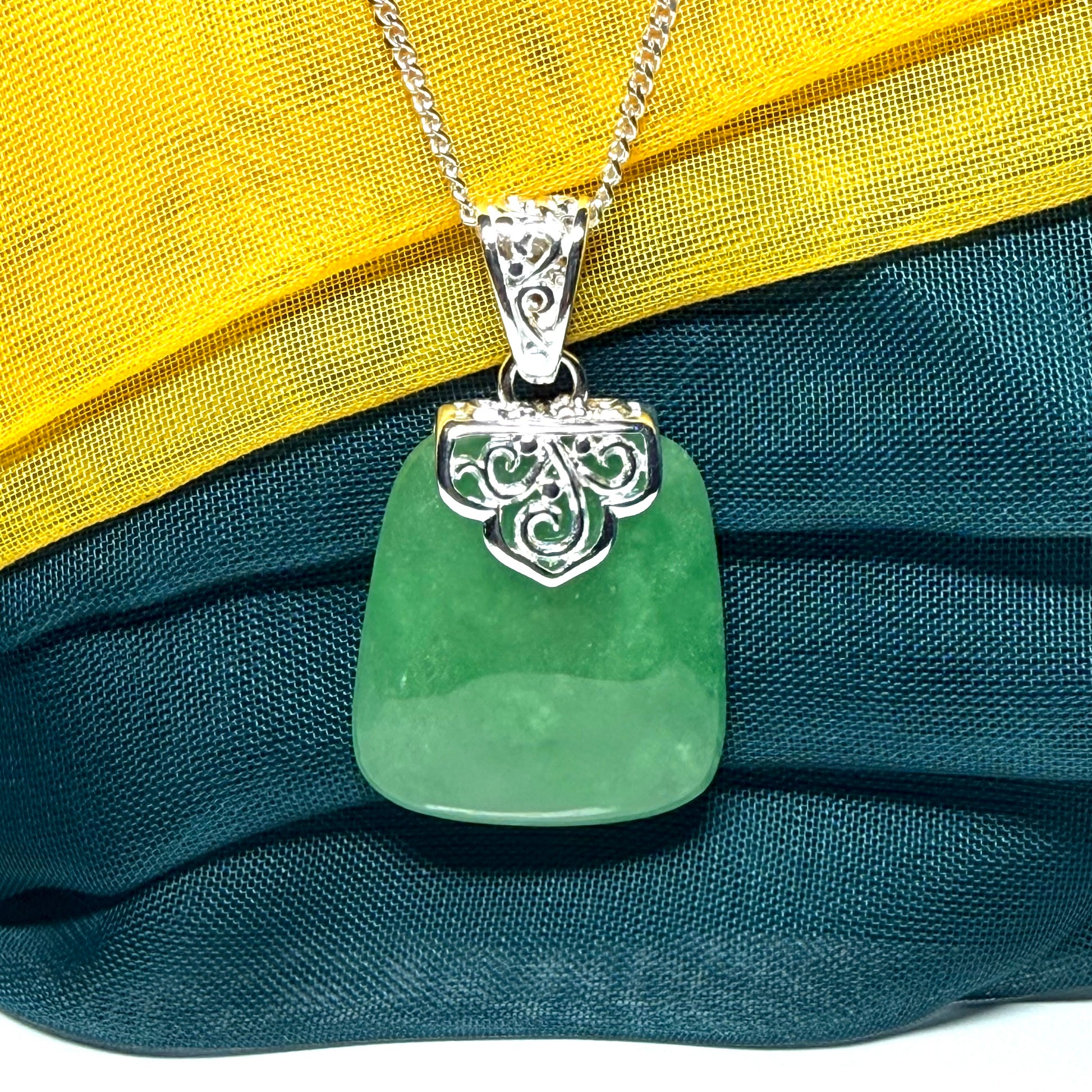A beautiful and truly timeless real green jade necklace large pendant that is cushion shaped