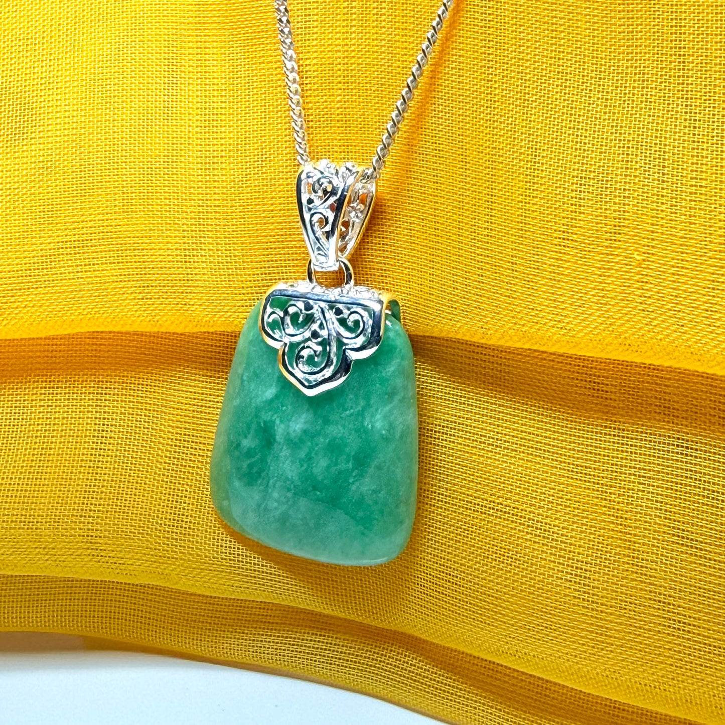 A beautiful real green jade necklace with a large shaped and patterned top pendant with chain Included