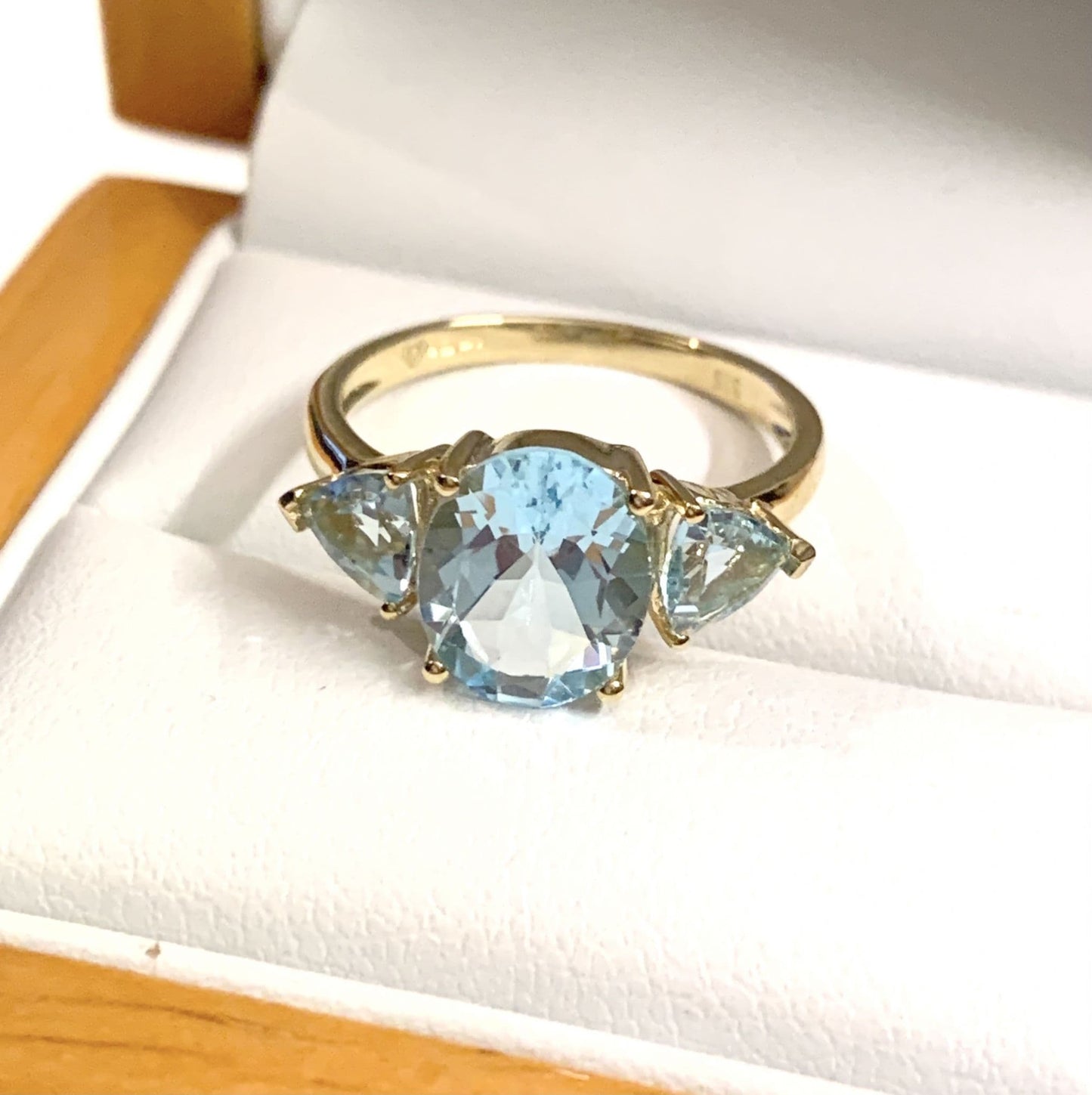 Blue topaz trilogy dress ring yellow gold