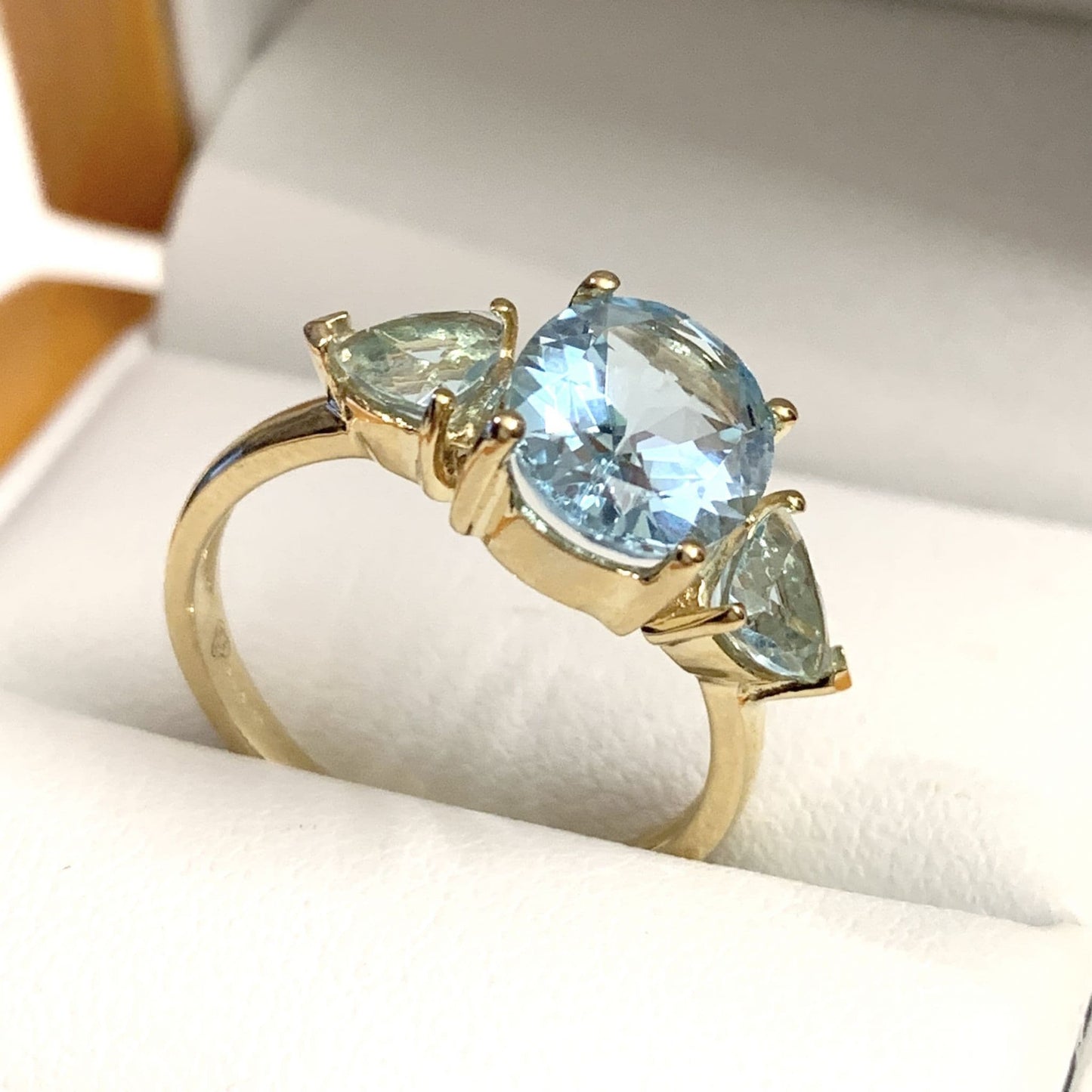 Blue topaz trilogy dress ring yellow gold