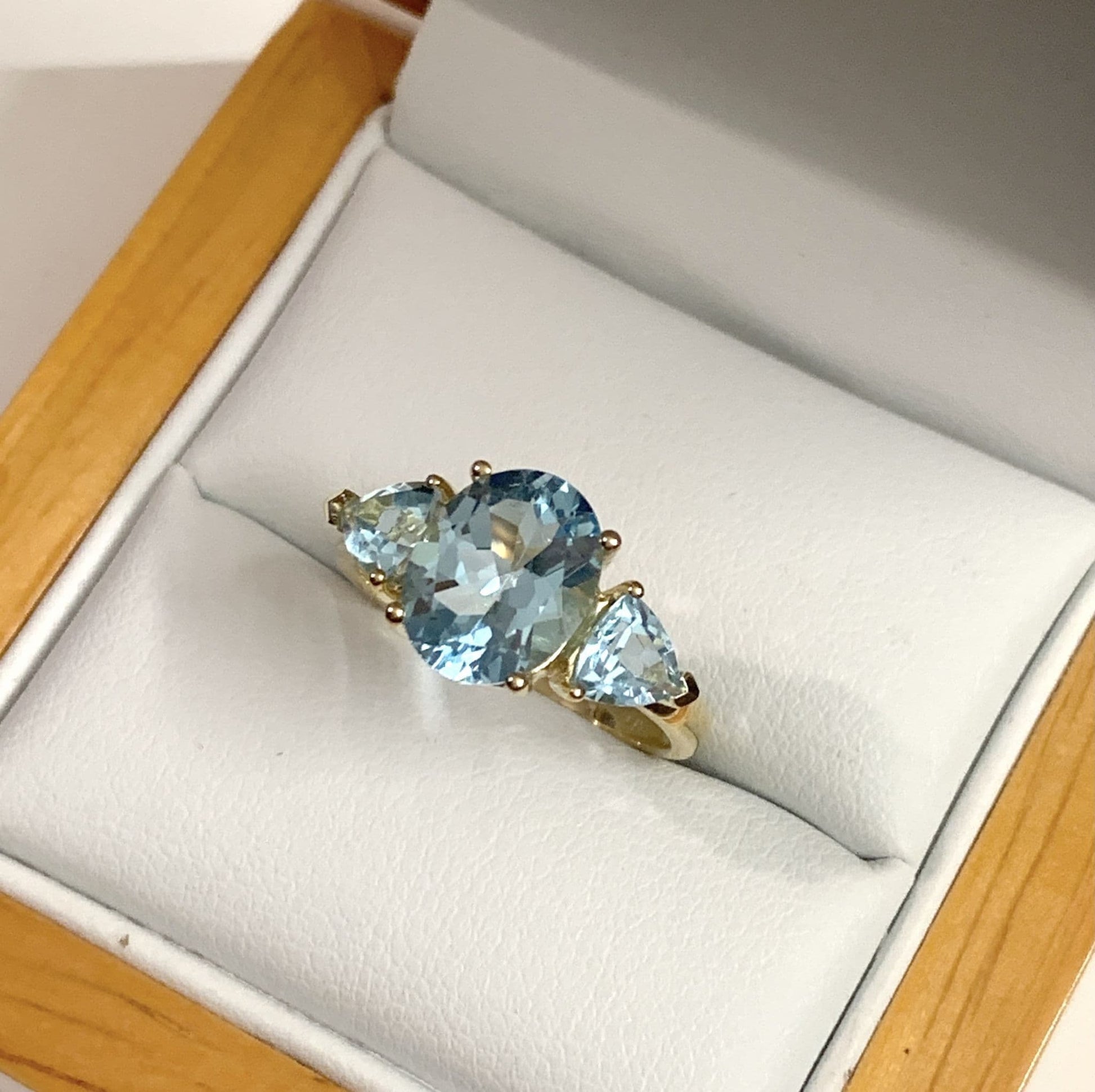 Blue topaz trilogy dress ring yellow gold