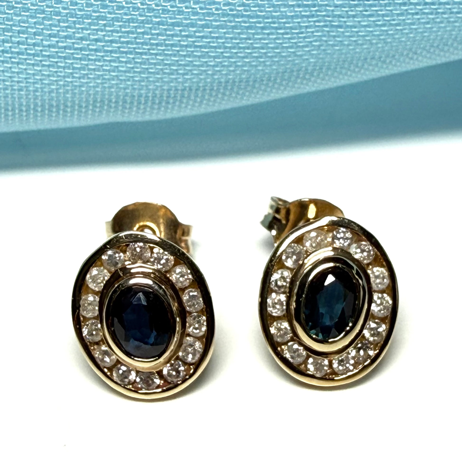 Blue real dark blue sapphire and diamond stud earrings yellow gold oval shaped cluster
