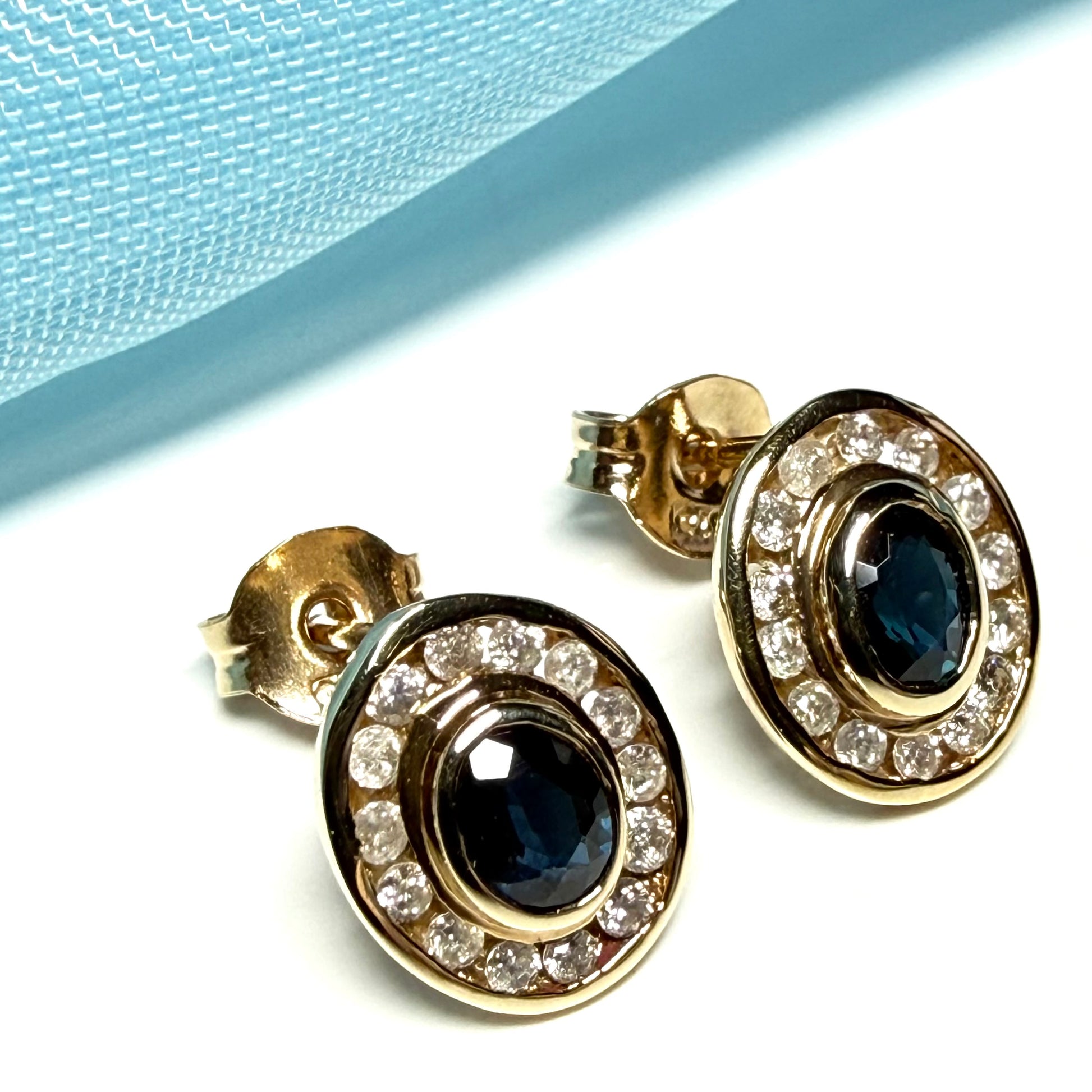 Blue real dark blue sapphire and diamond stud earrings yellow gold oval shaped cluster