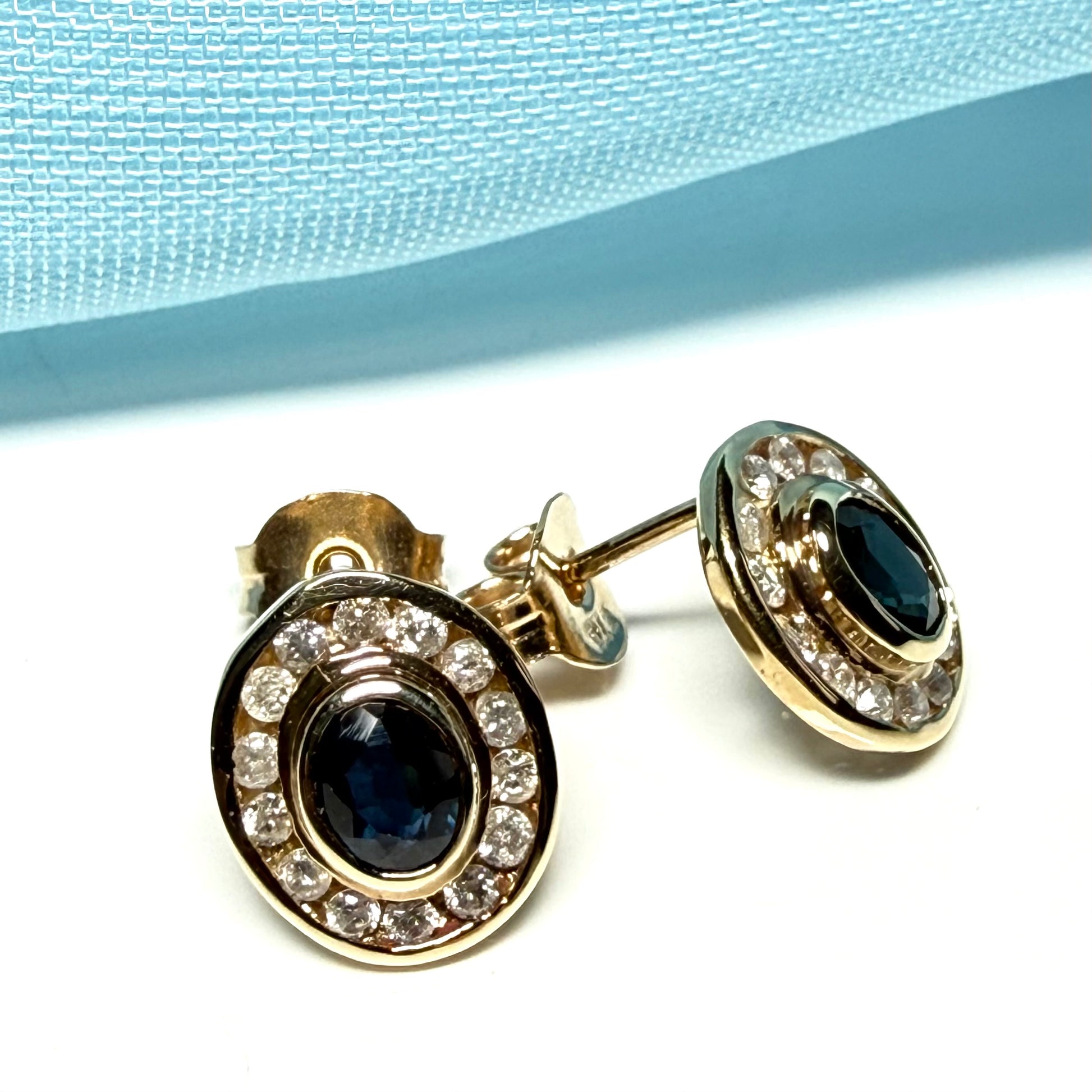 Blue real dark blue sapphire and diamond stud earrings yellow gold oval shaped cluster