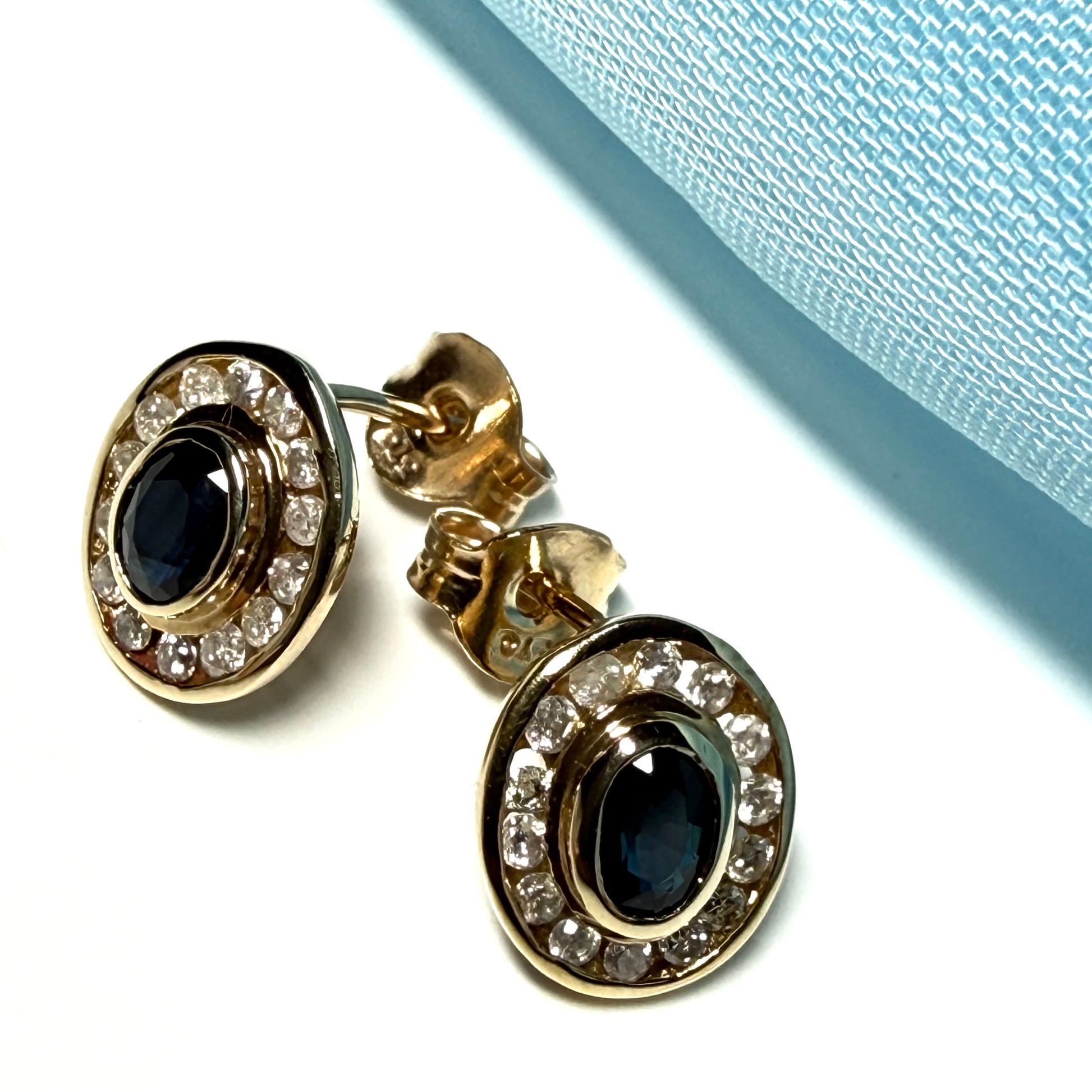 Blue real dark blue sapphire and diamond stud earrings yellow gold oval shaped cluster