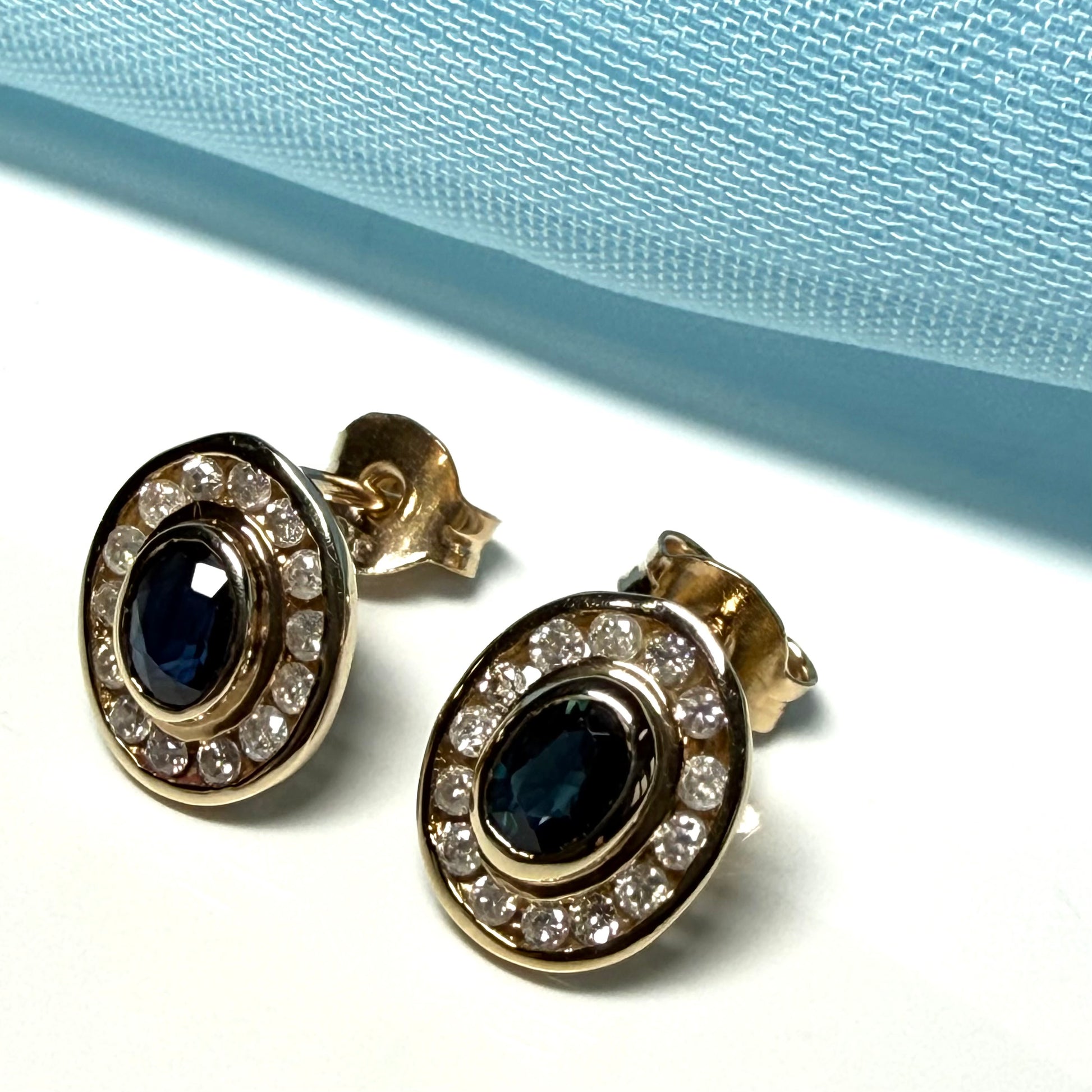 Blue real dark blue sapphire and diamond stud earrings yellow gold oval shaped cluster