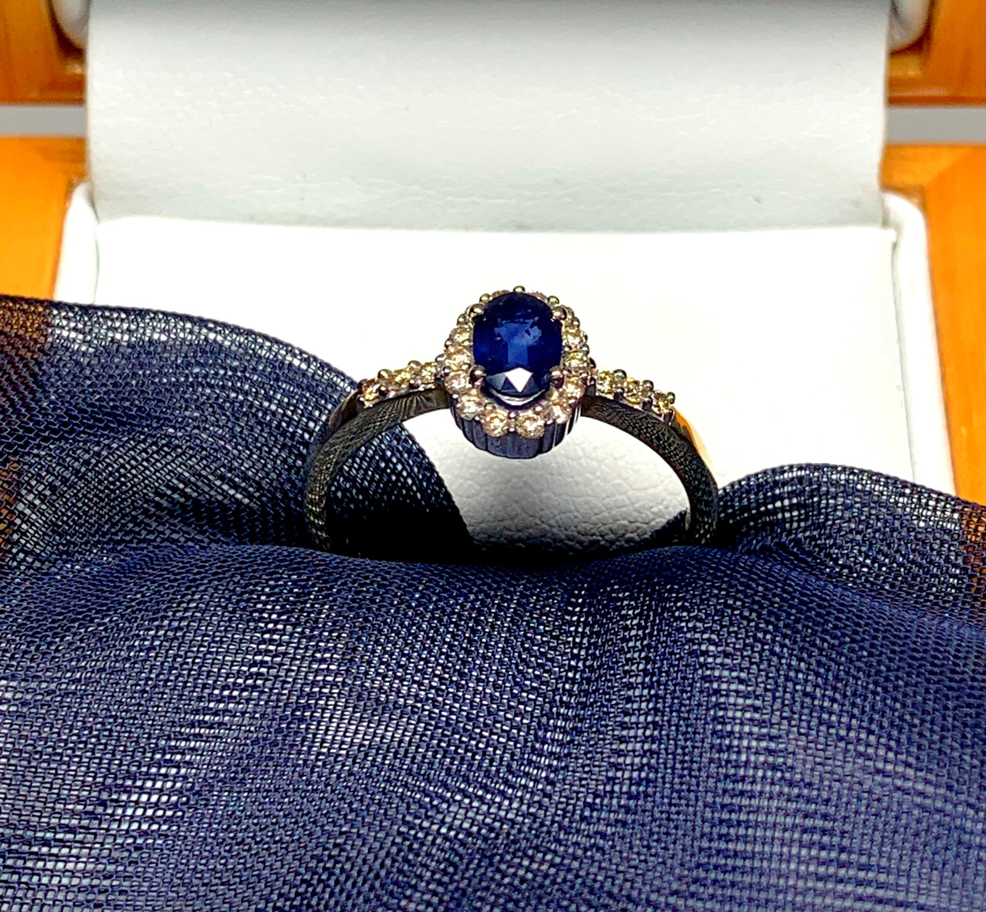 Dark blue sapphire diamond yellow gold oval cluster ring with diamond set shoulders