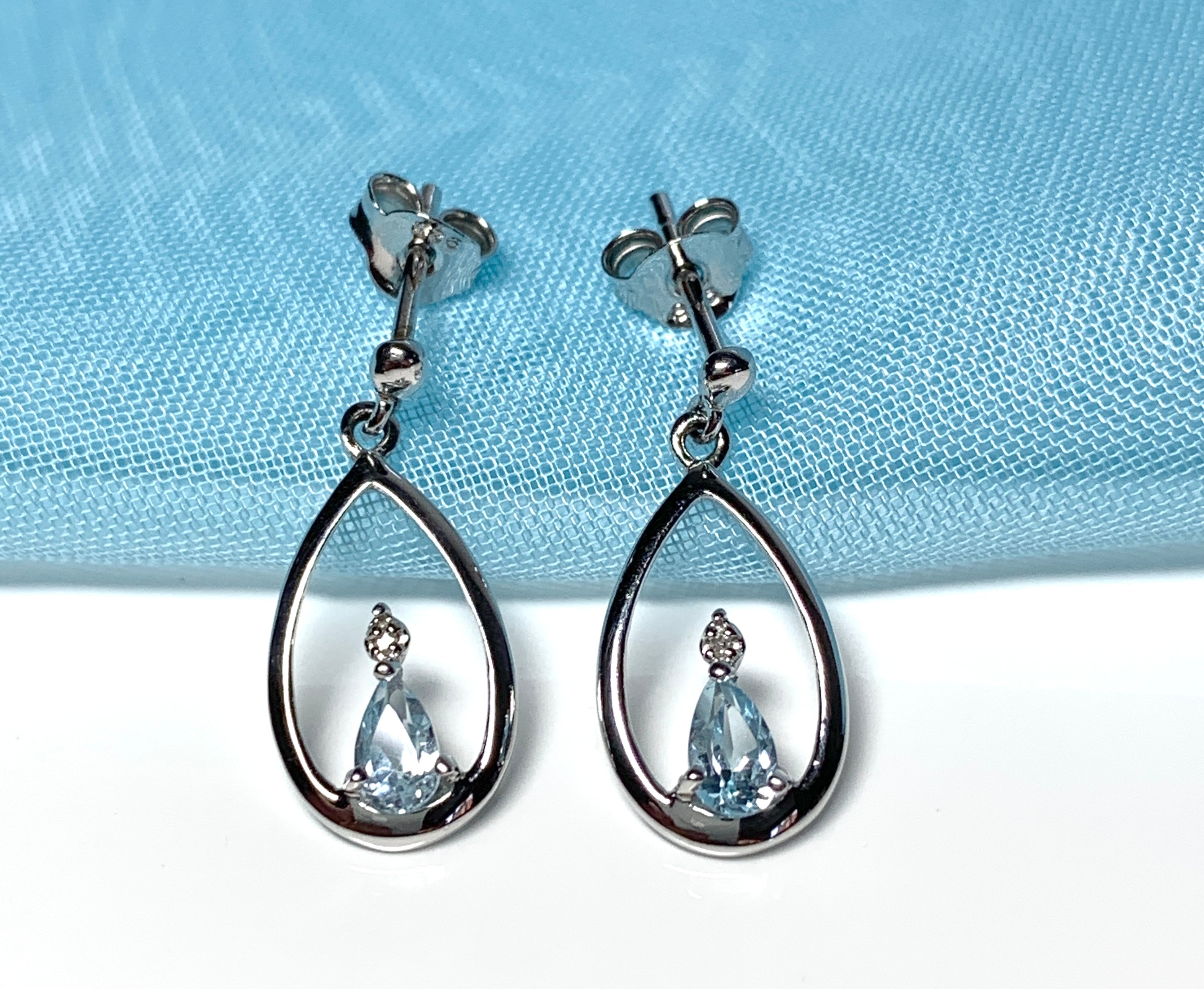 Blue topaz pear shaped sterling silver diamond set drop earrings