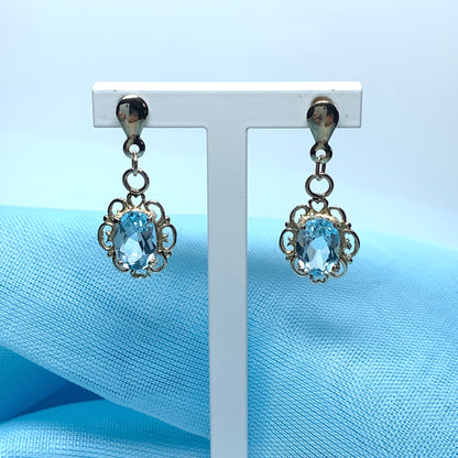 Blue topaz yellow gold oval shaped fancy scrolled drop earrings