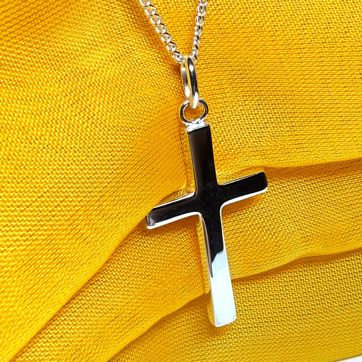 Cross and chain highly polished with an oval pendant loop on top of it chain included