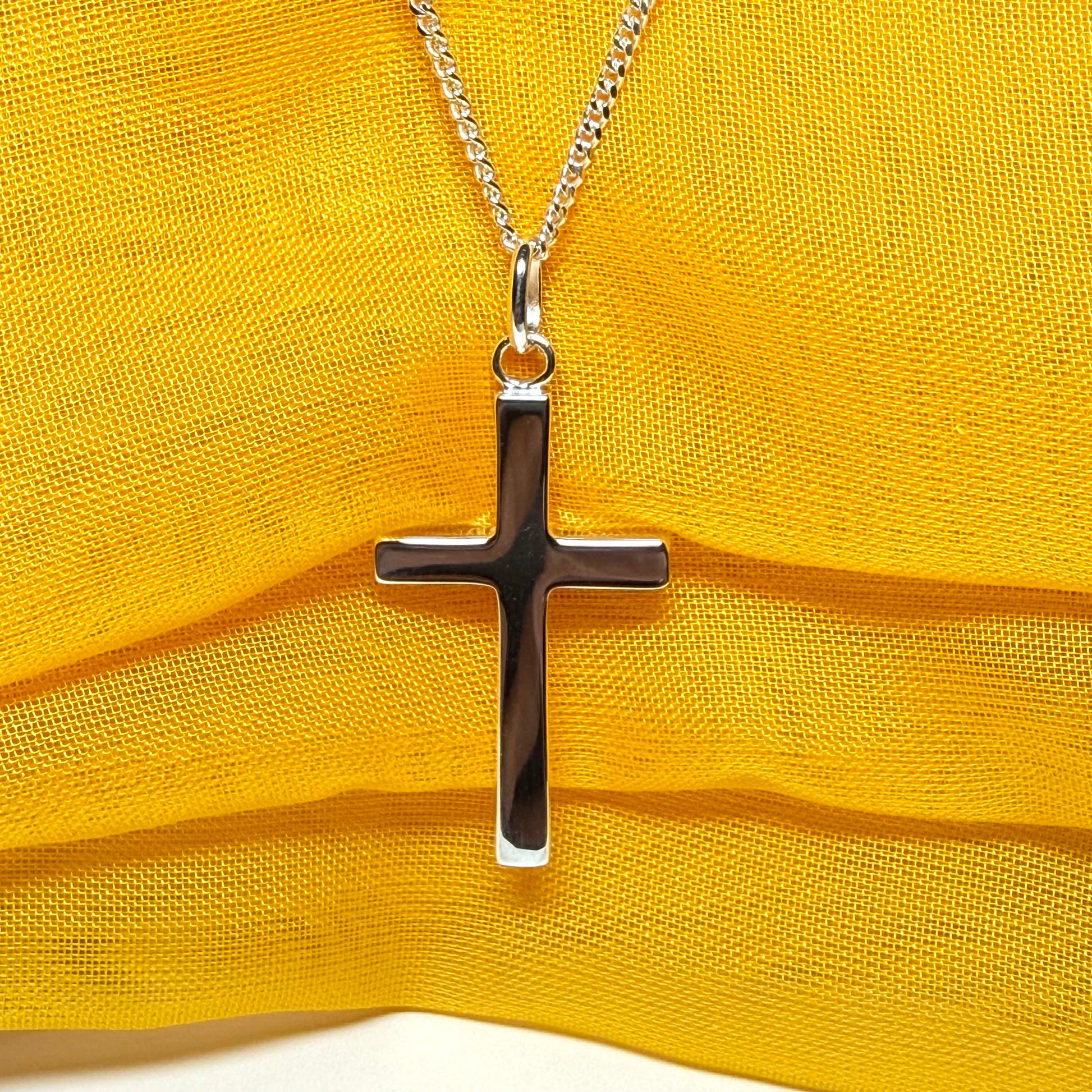Cross and chain highly polished with an oval pendant loop on top of it chain included