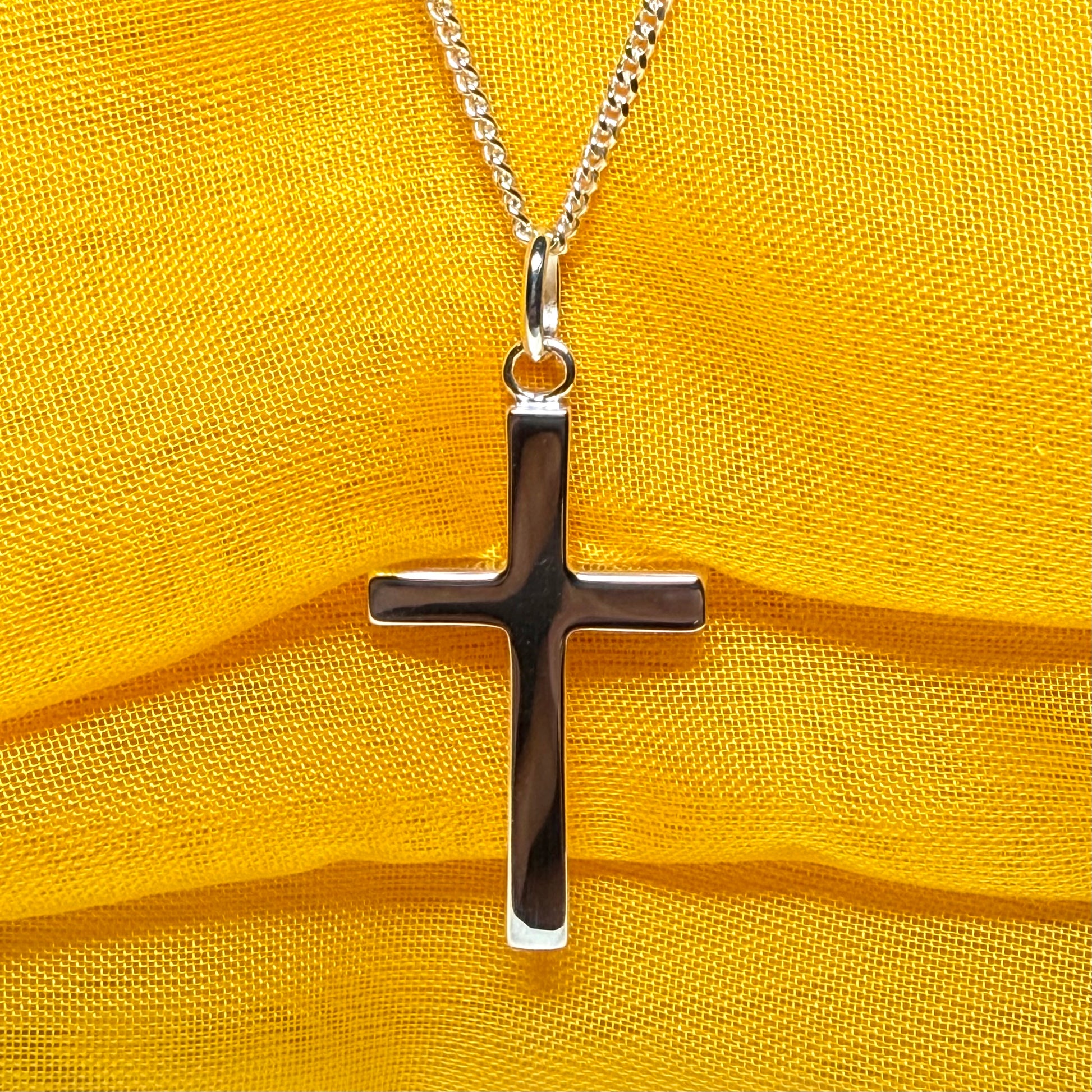 Cross and chain highly polished with an oval pendant loop on top of it chain included