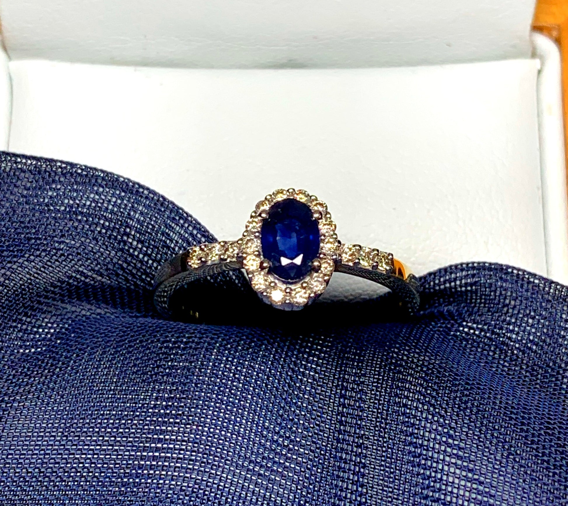 Dark blue sapphire diamond yellow gold oval cluster ring with diamond set shoulders