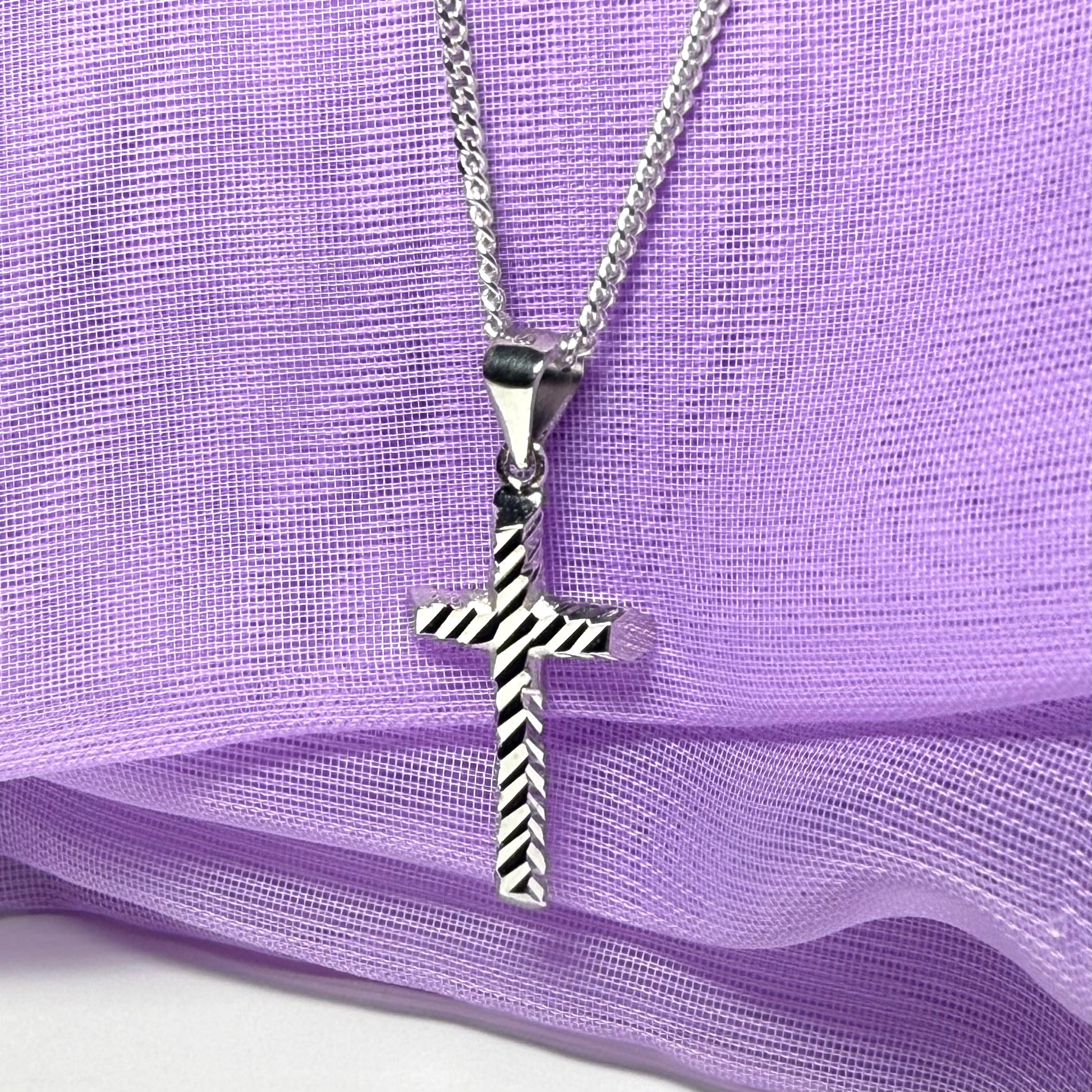 Diamond cut cross patterned sterling silver with a chain Included