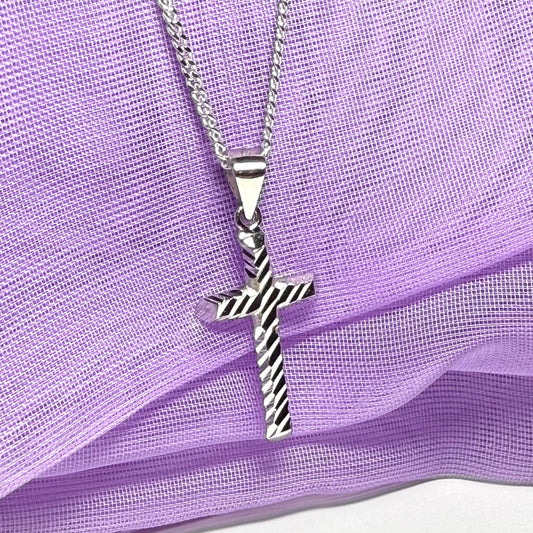 Diamond cut cross patterned sterling silver with a chain Included