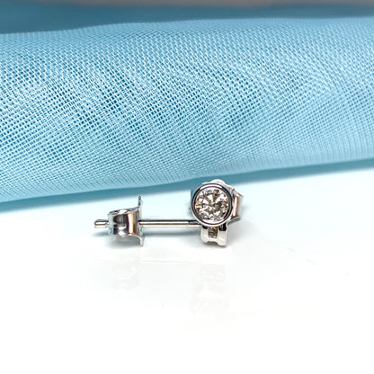 Diamond stud earrings rubbed over single stone smooth setting 25 Points