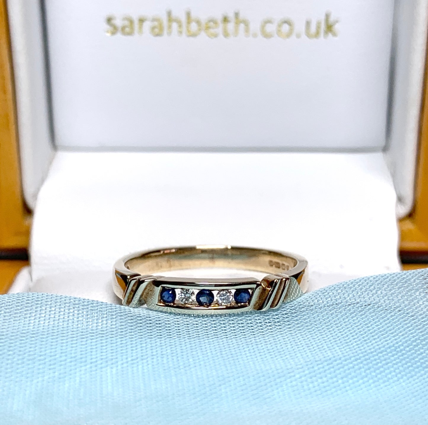 Eternity ring sapphire and diamond channel set yellow gold