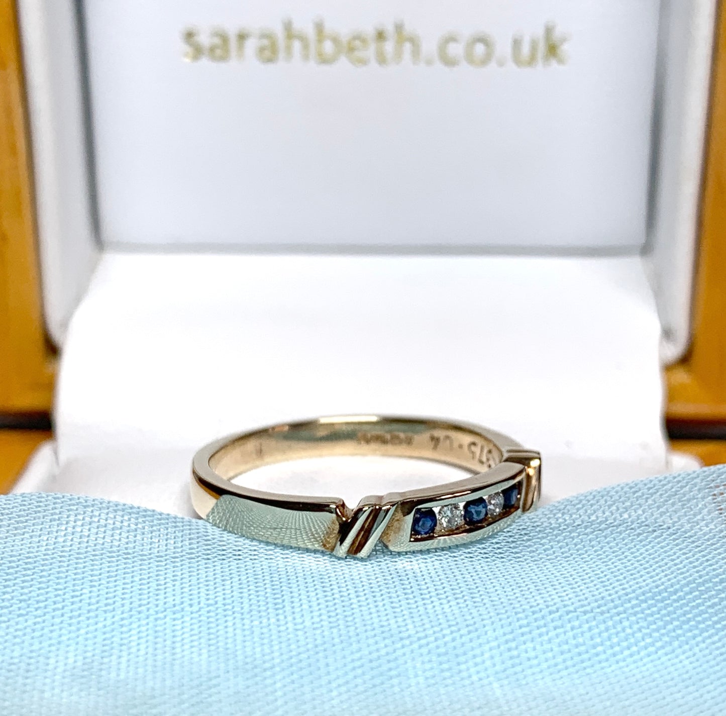 Eternity ring sapphire and diamond channel set yellow gold