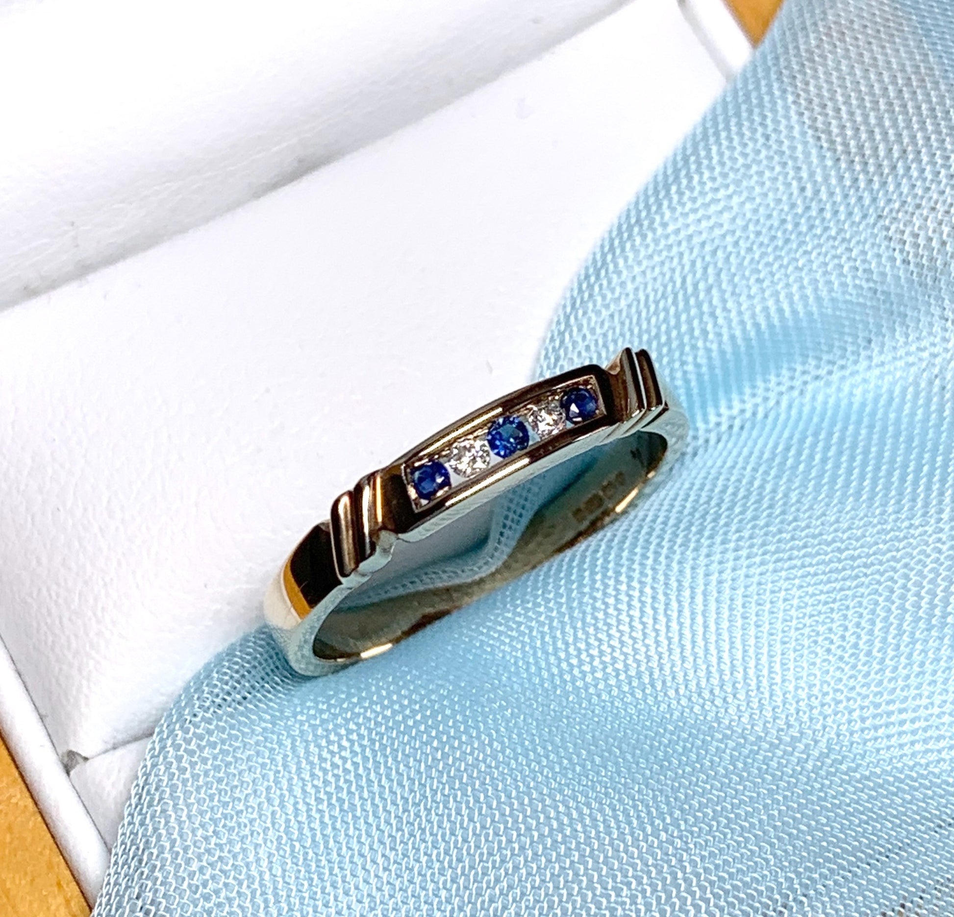 Eternity ring sapphire and diamond channel set yellow gold