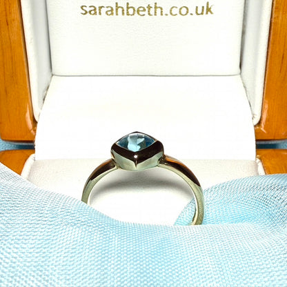 Blue topaz ladies dress ring yellow gold with a smooth rubbed over setting