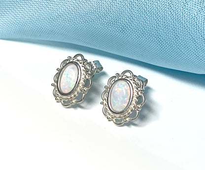 Fancy oval sterling silver opal stud earrings