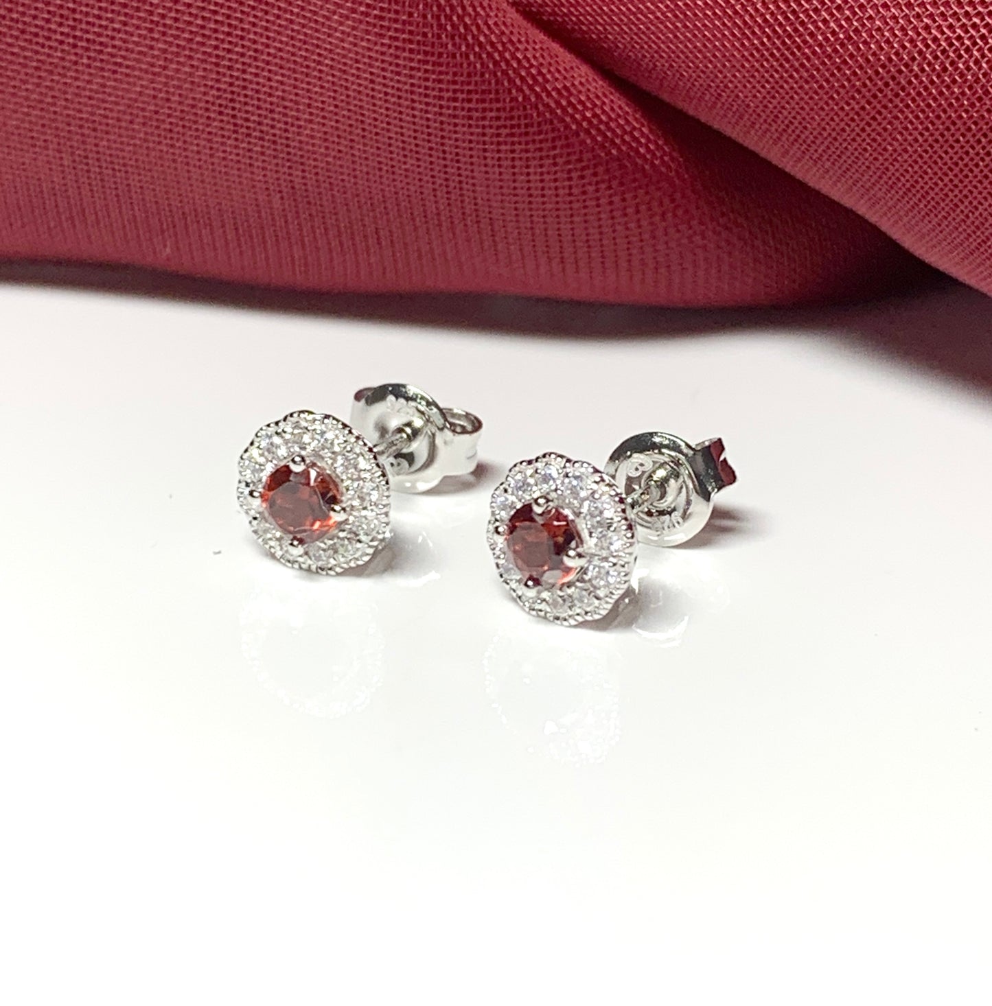 Garnet and cubic zirconia sterling silver round cluster stud earrings