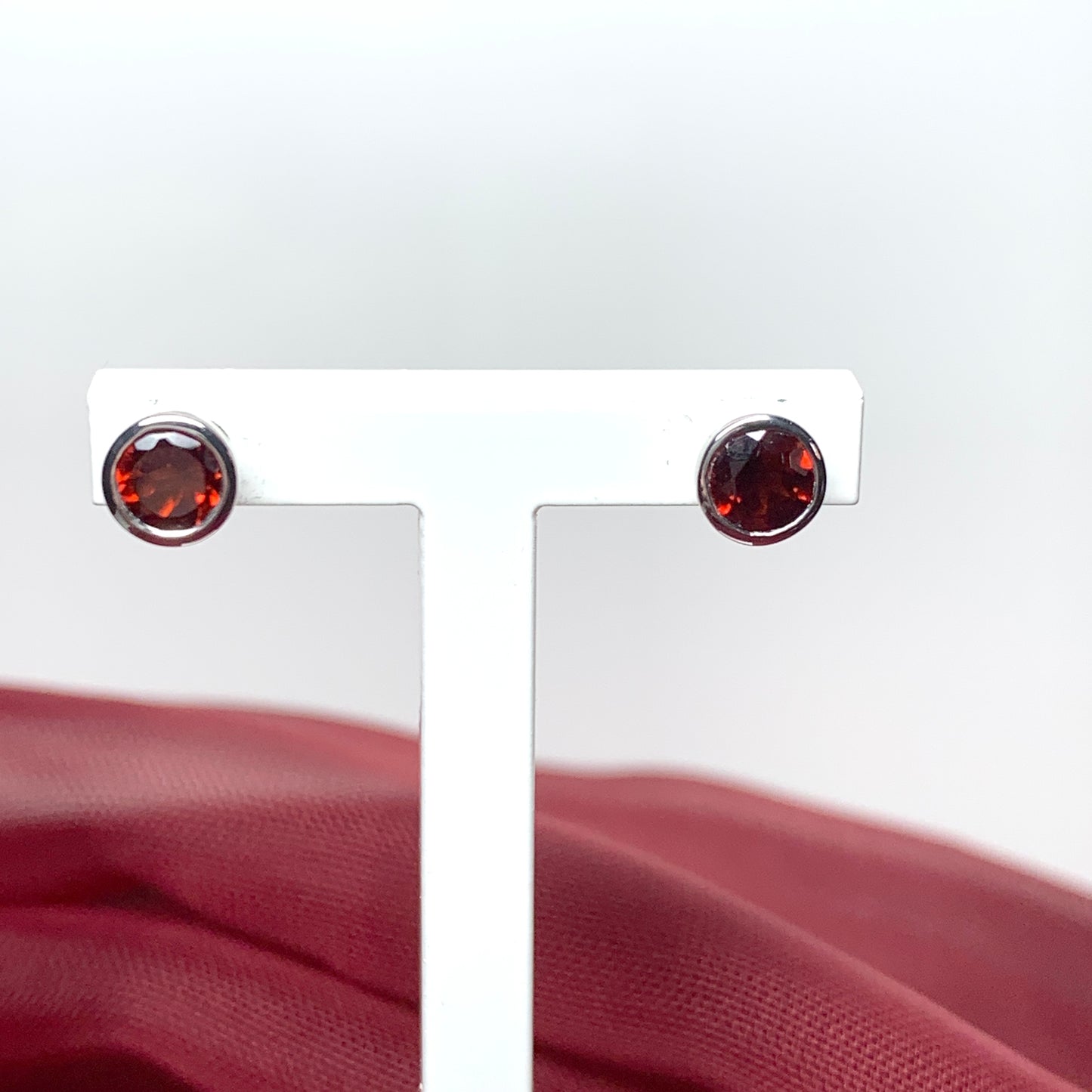 Garnet silver round stud earrings smooth rubbed over setting
