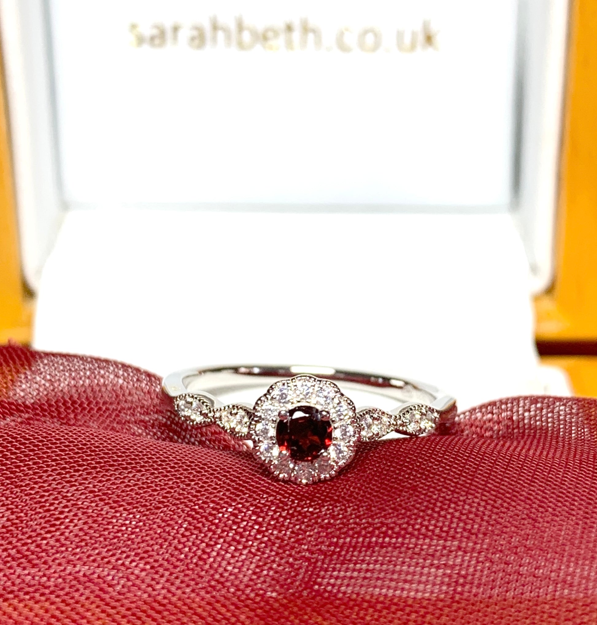 Garnet and cubic zirconia sterling silver round dress cluster ring