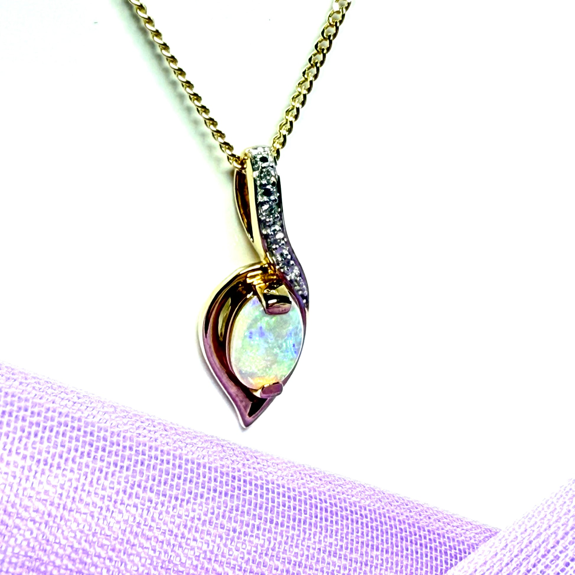 Gold real opal and real diamond necklace pendant oval shaped in a swirl design