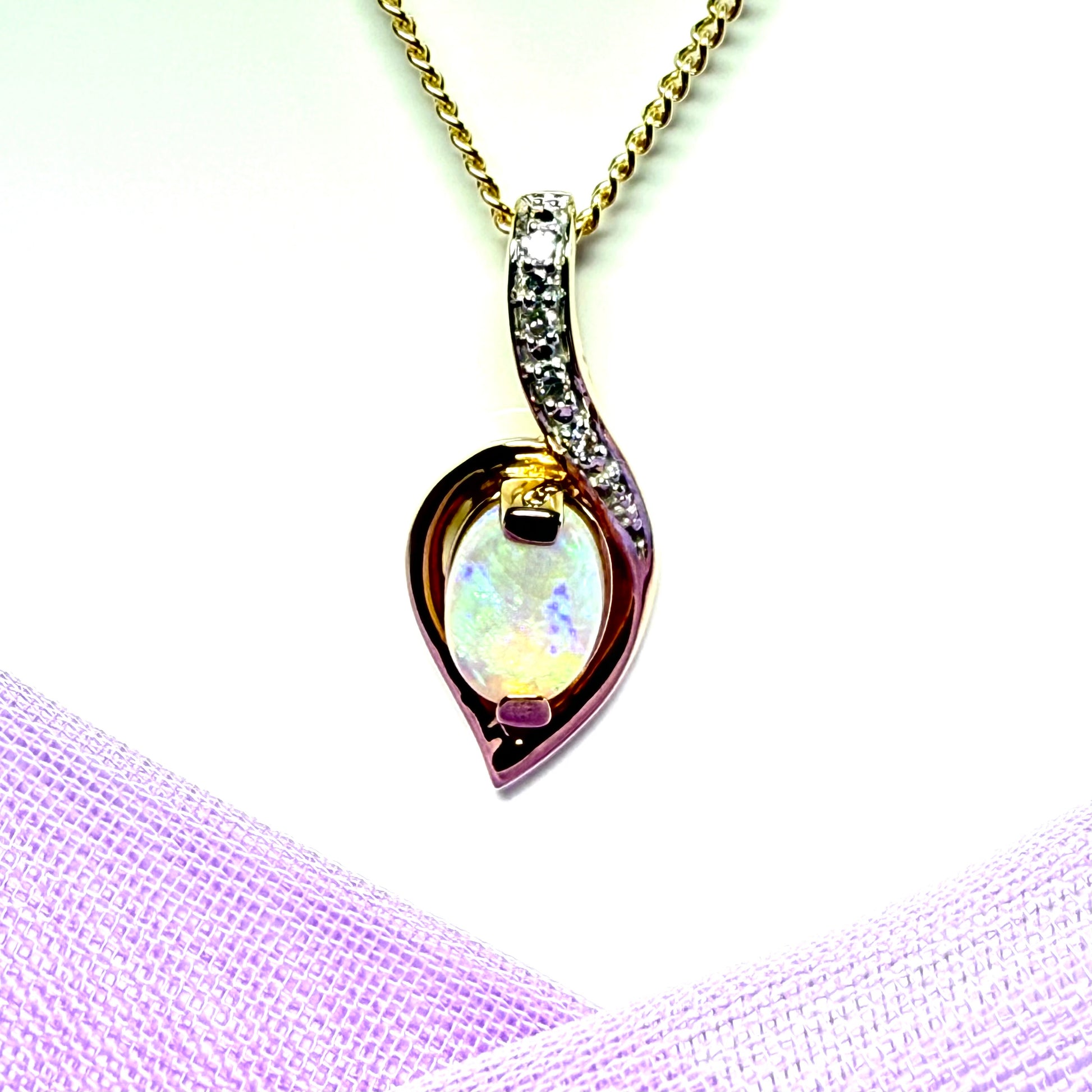 Gold real opal and real diamond necklace pendant oval shaped in a swirl design