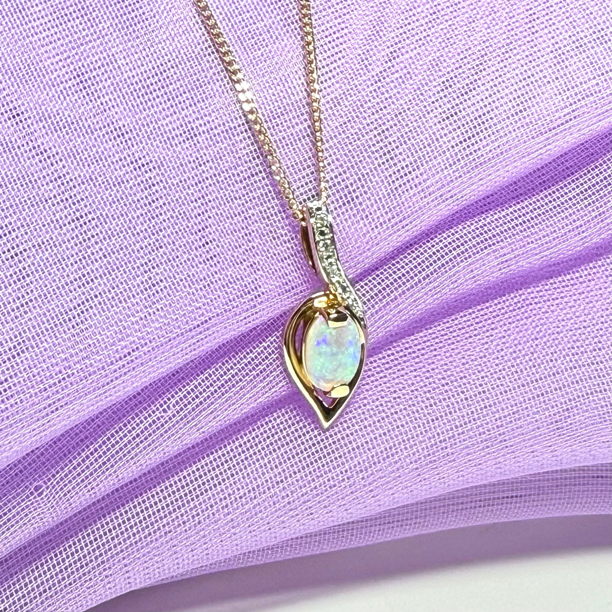 Gold real opal and real diamond necklace pendant oval shaped in a swirl design