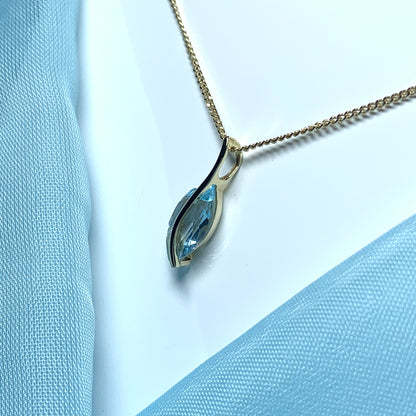 Yellow gold real blue topaz fancy swirl marquise shaped necklace pendant