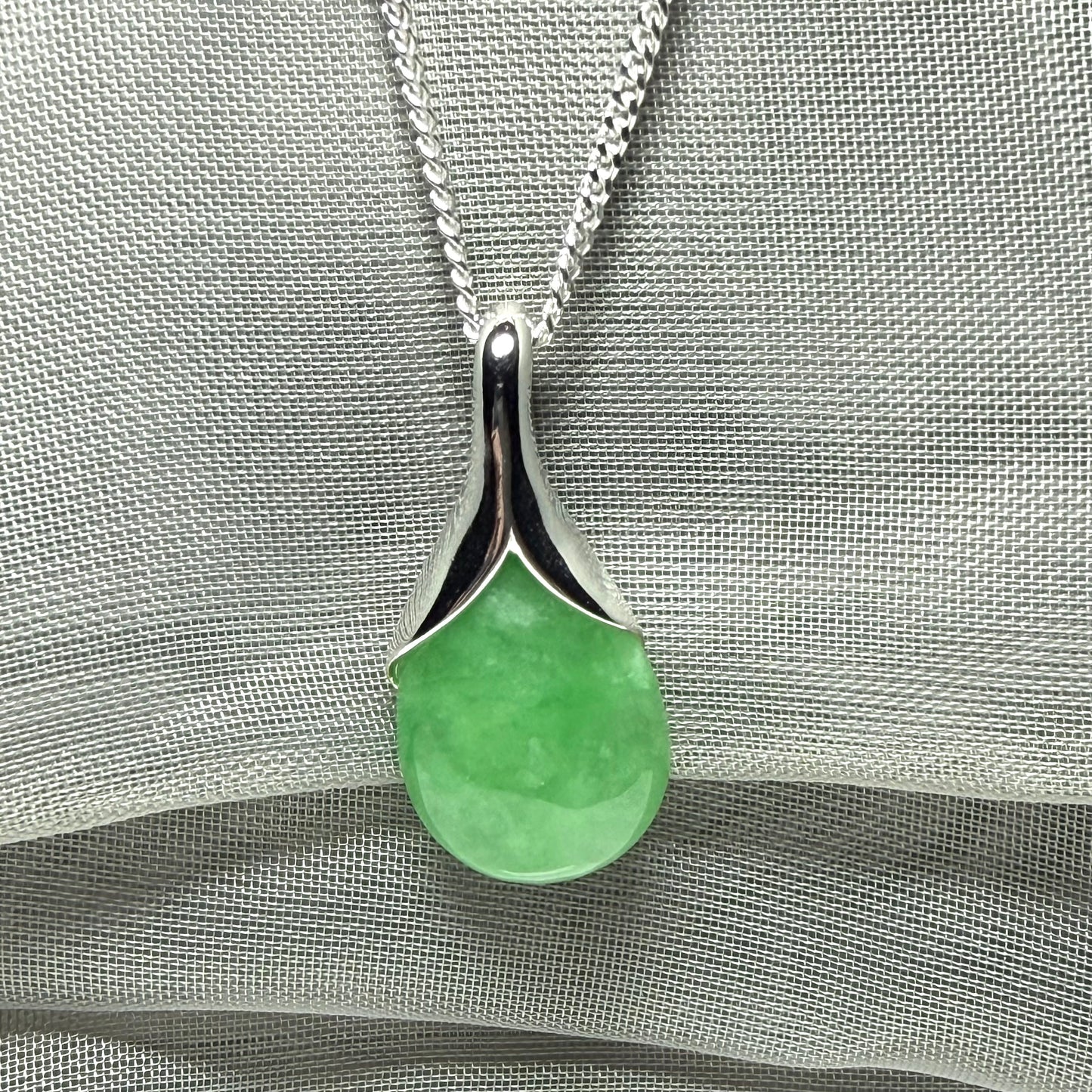 A gorgeous real green jade necklace teardrop with a pear shaped pendant to it