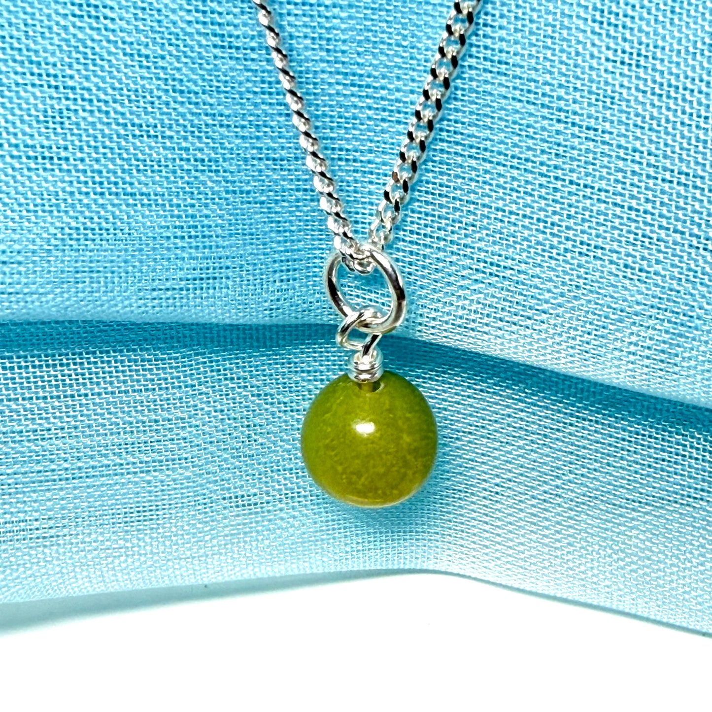 A gorgeous small real green gypsum necklace ball shaped, a really gorgeous round pendant with chain too