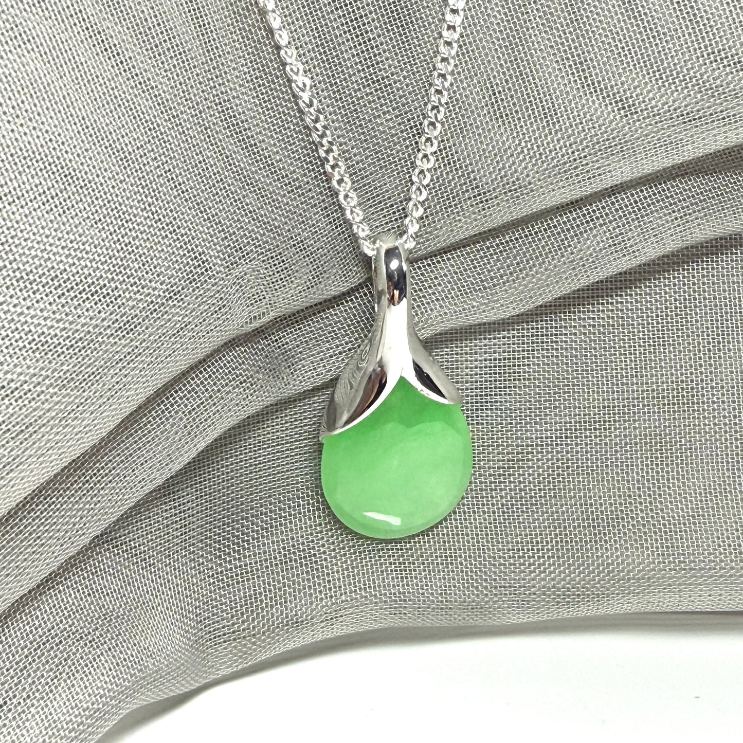 Green jade cushion shaped silver necklace pendant, a stunning design
