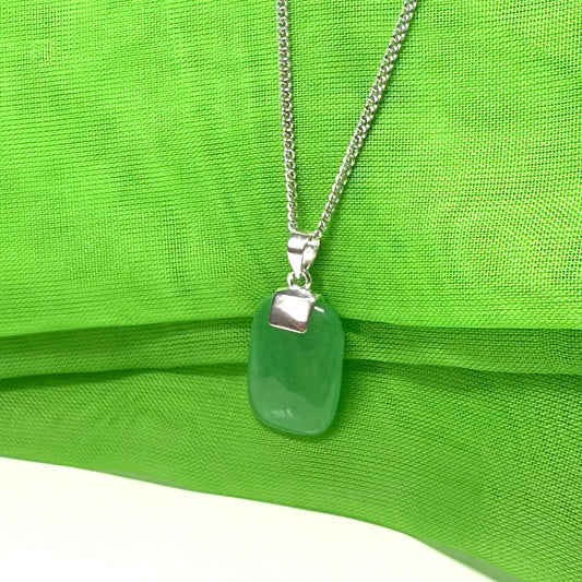Green jade cushion shaped silver necklace pendant, a timeless design